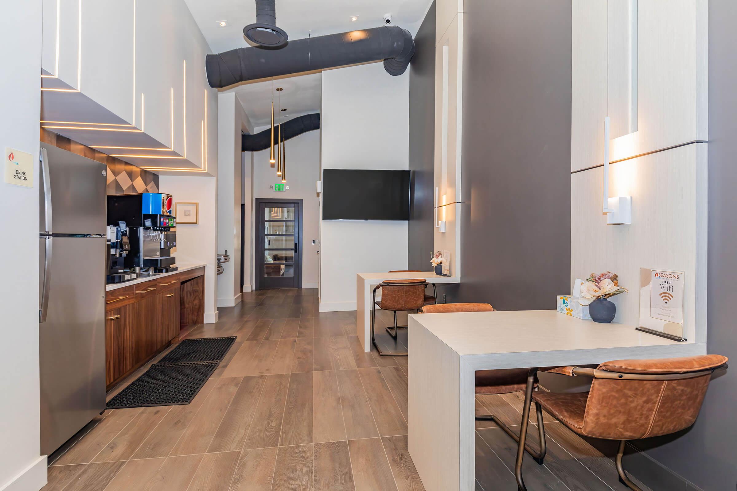 a kitchen with a refrigerator and table in a room