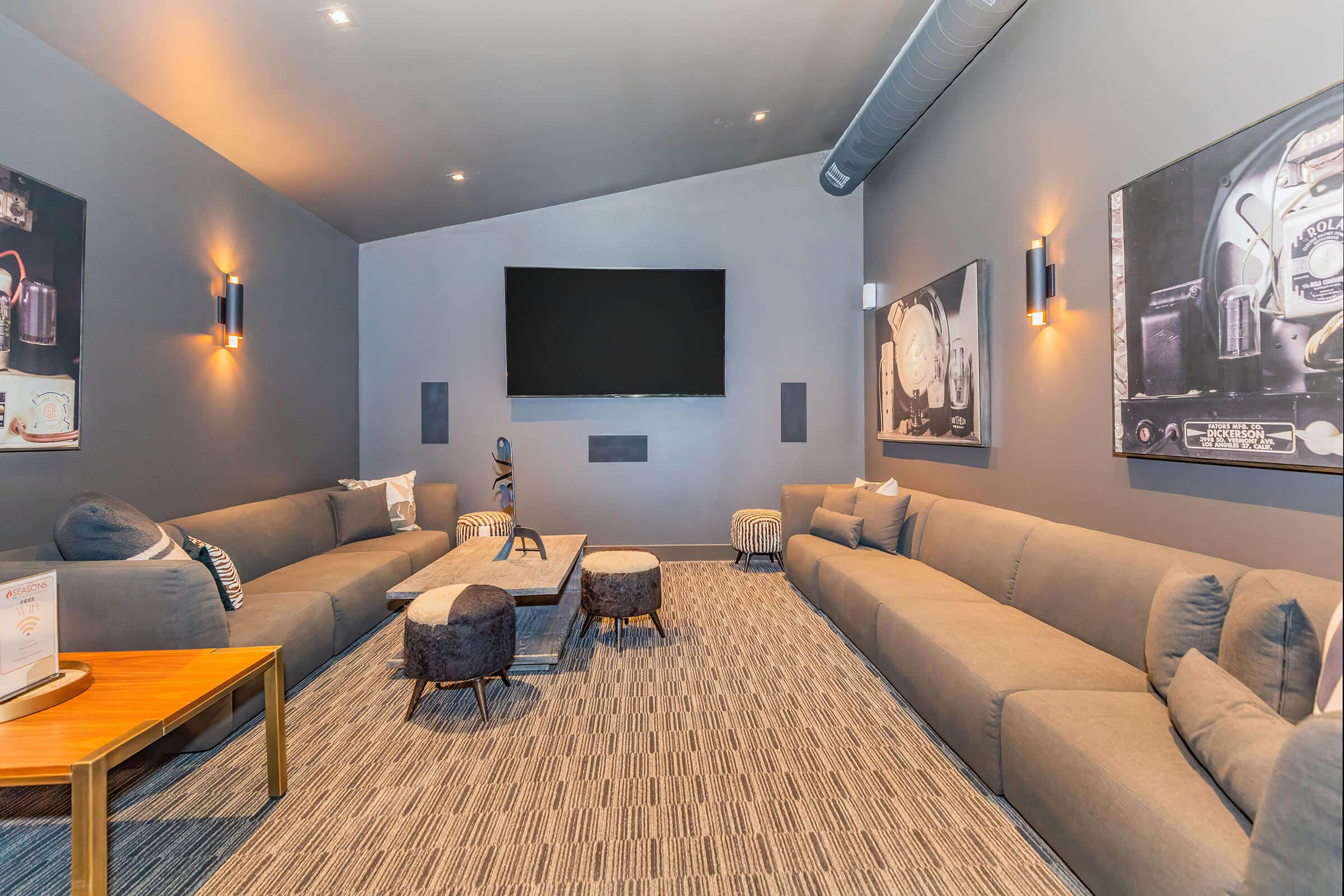 a living room with a flat screen tv sitting on top of a bed