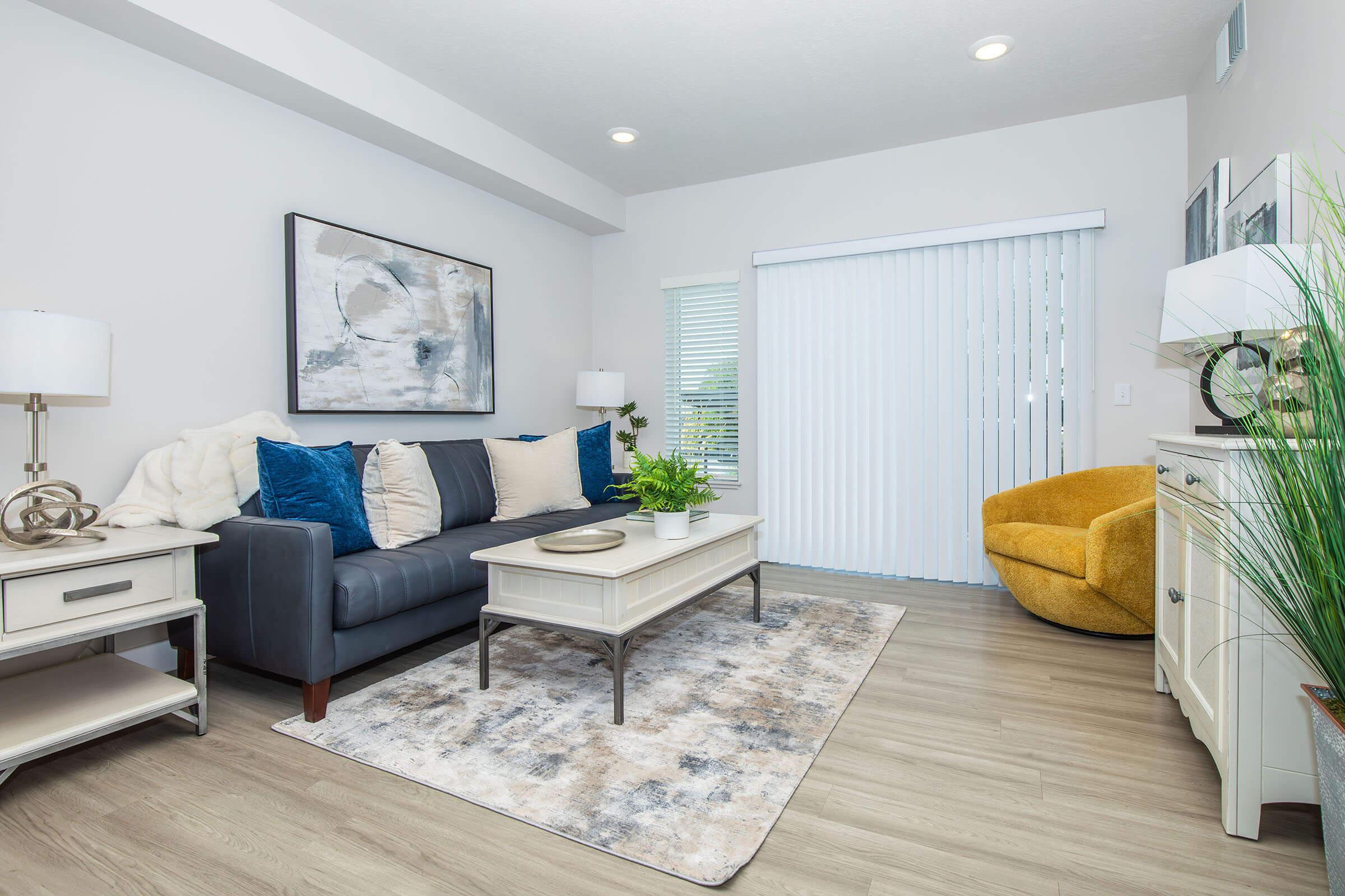 a living room filled with furniture and a flat screen tv