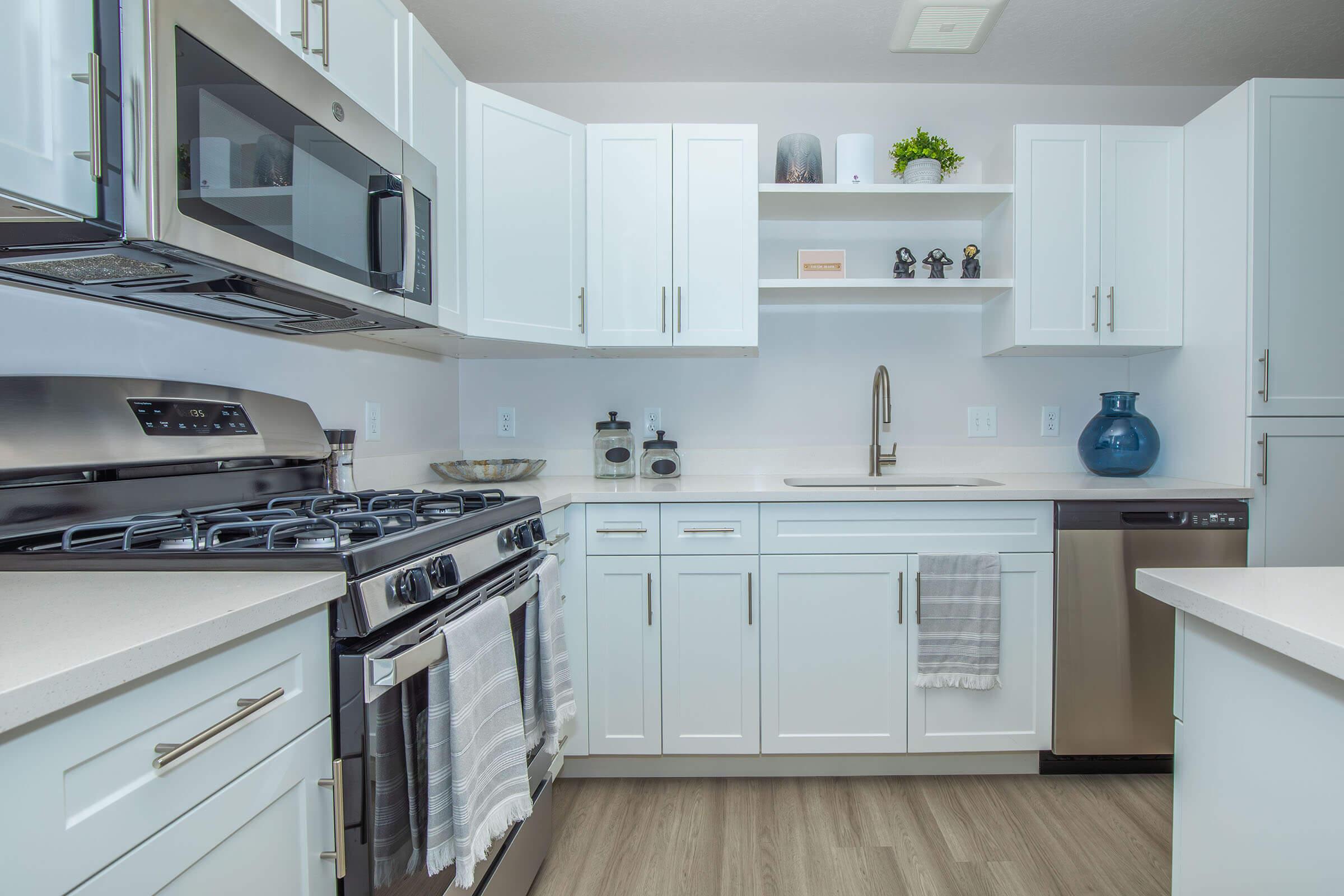 a kitchen with a stove a sink and a microwave