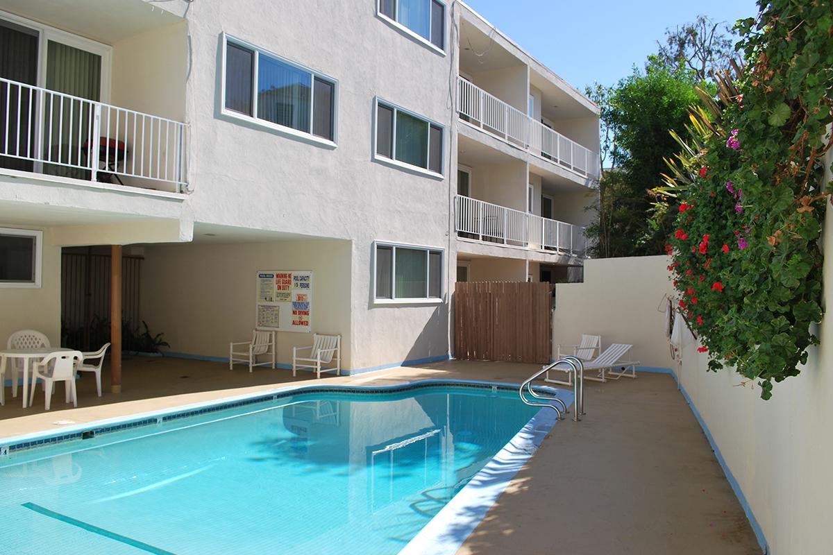 a room with a pool in front of a building