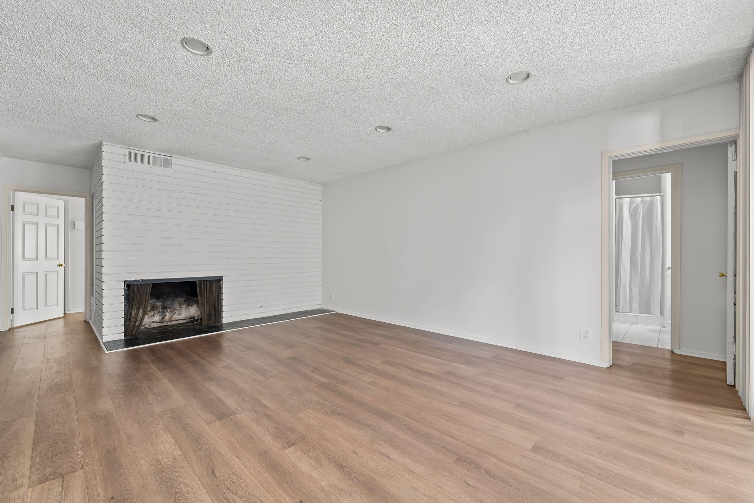 a large empty room with a wood floor