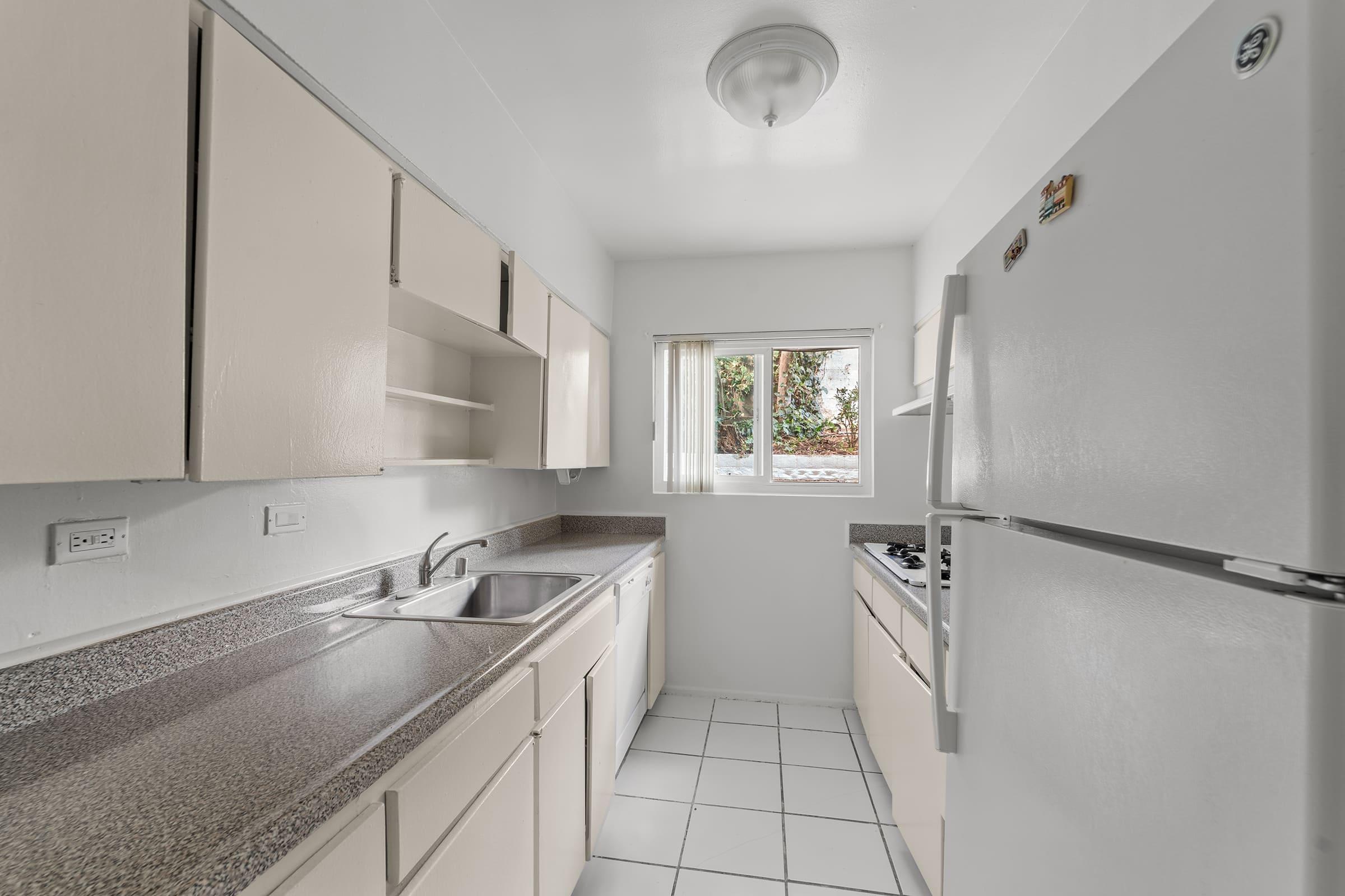 a kitchen with a sink and a mirror