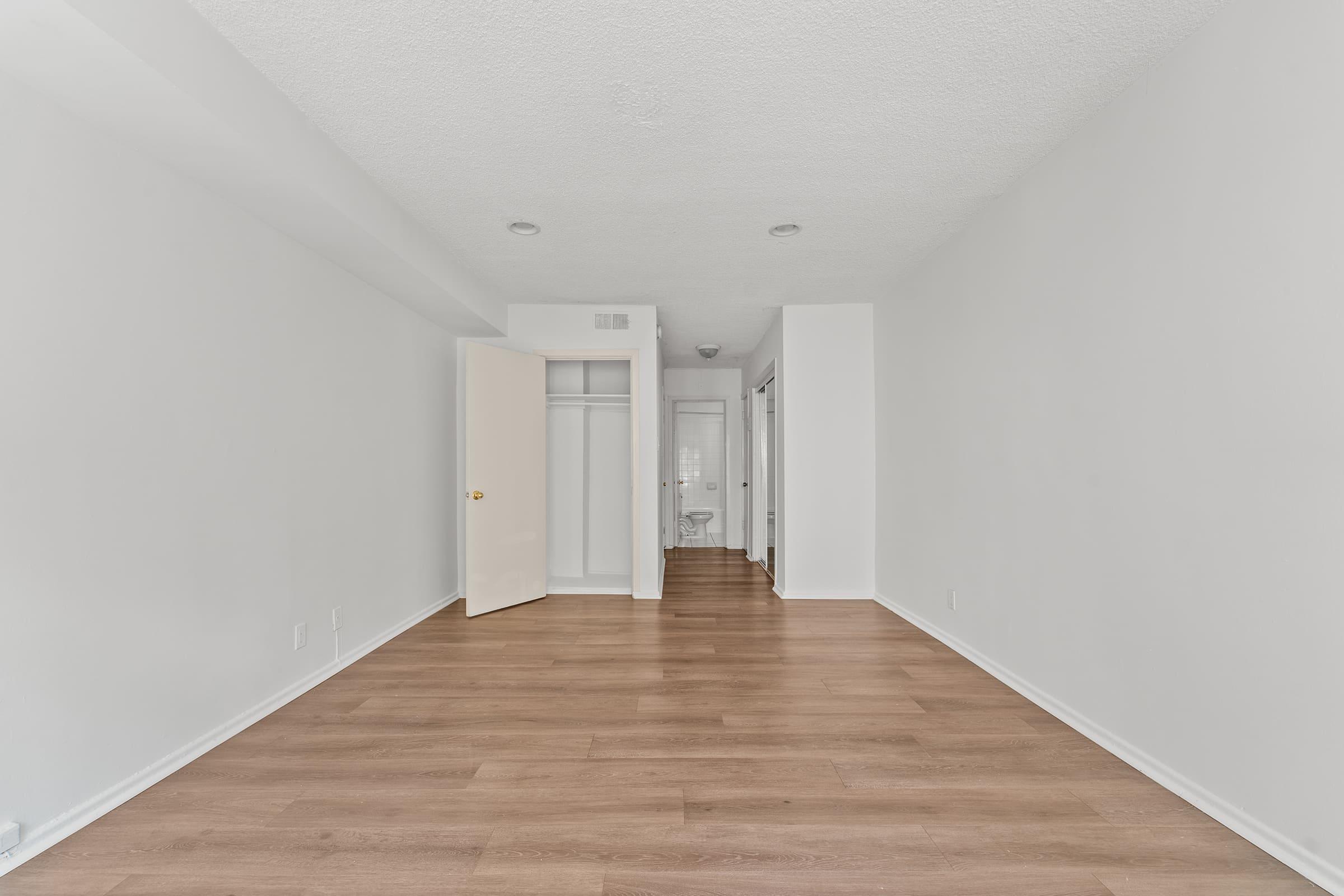 a large empty room with a wooden floor