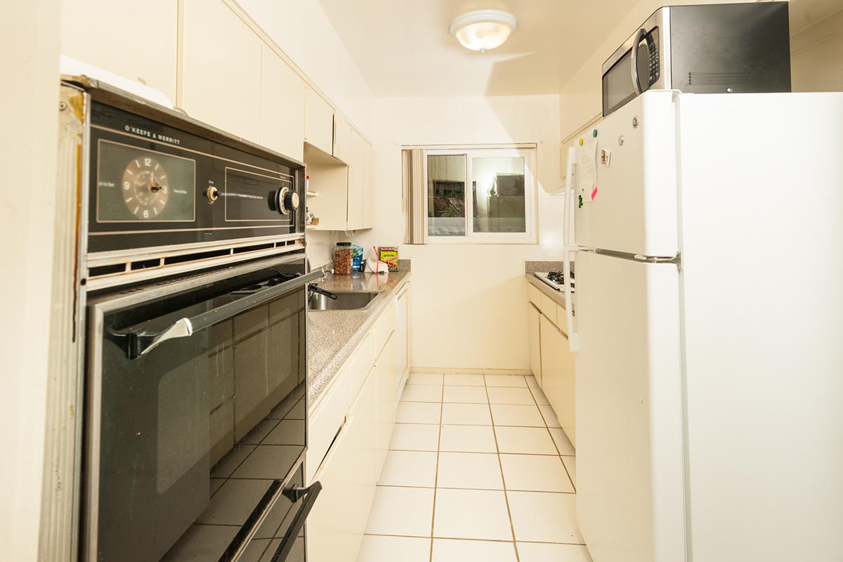 a white refrigerator freezer sitting inside of a kitchen