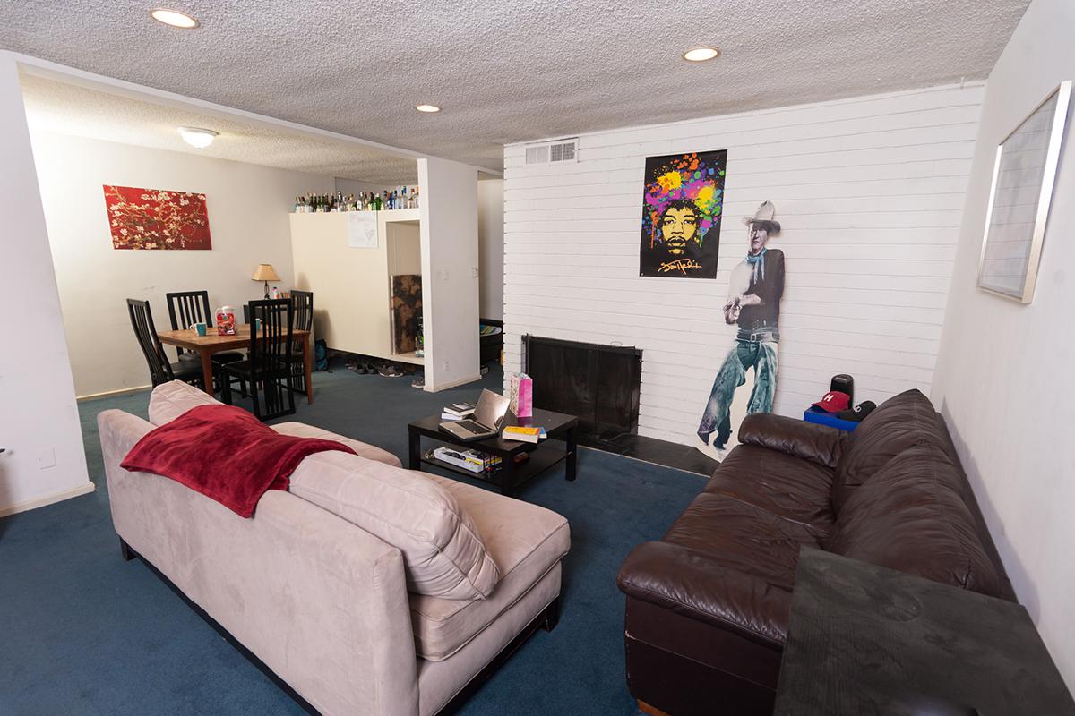 a living room filled with furniture and a flat screen tv