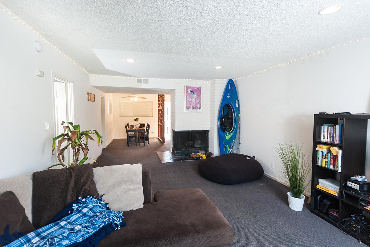 a living room filled with furniture and a flat screen tv