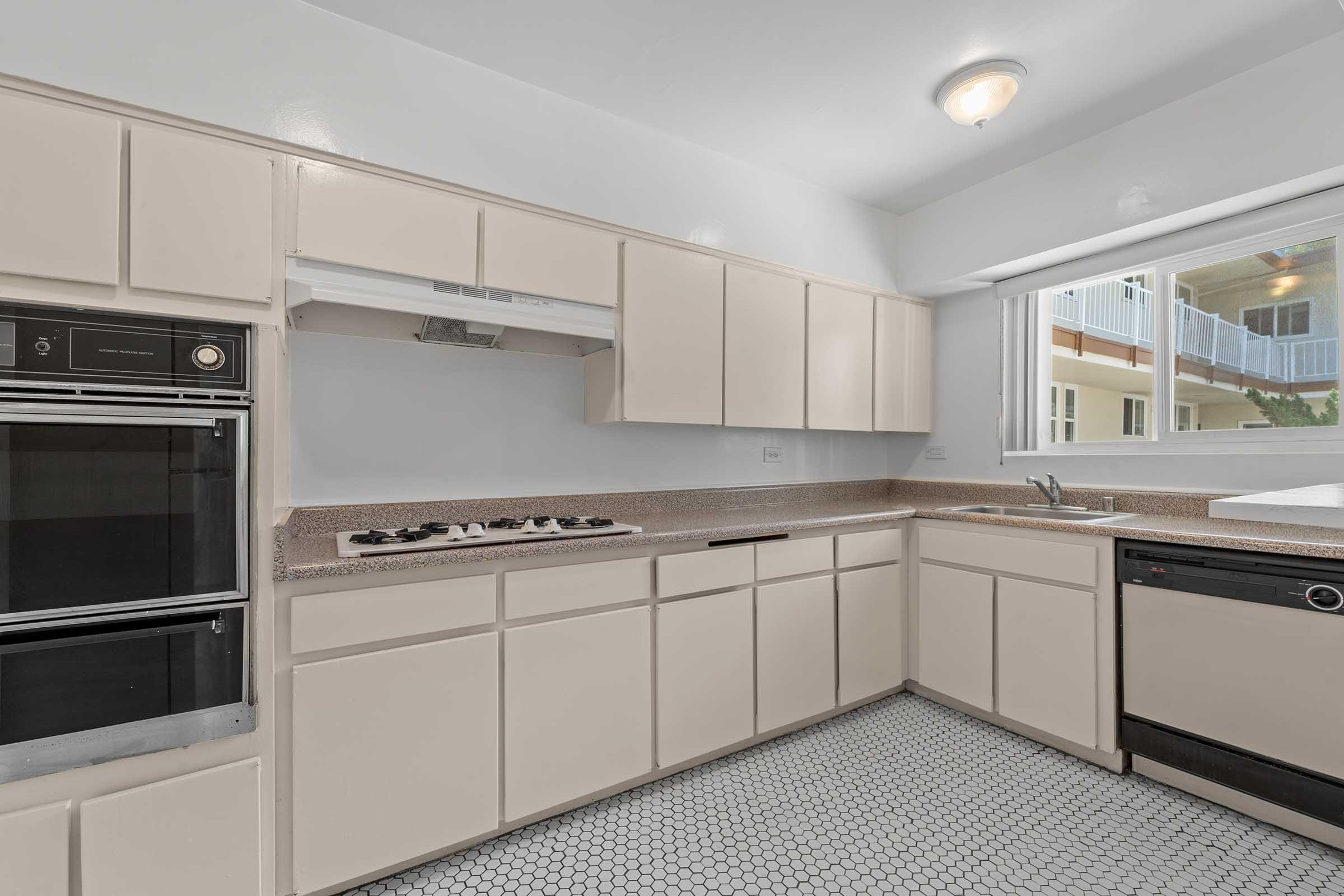 a kitchen with a stove top oven