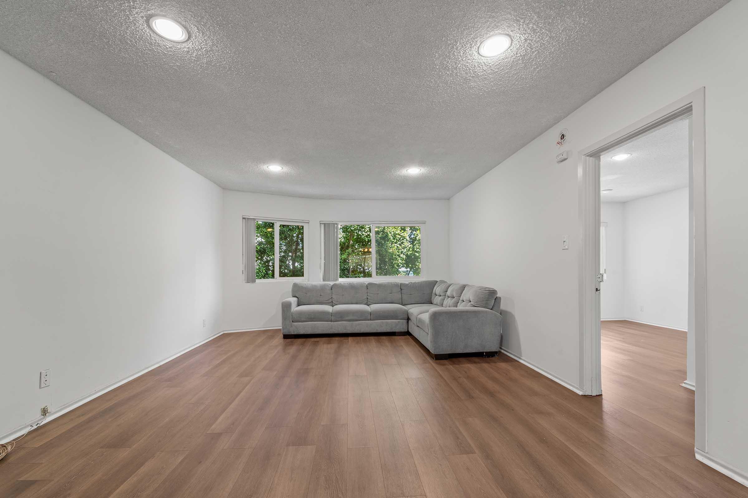 a large empty room with a wood floor