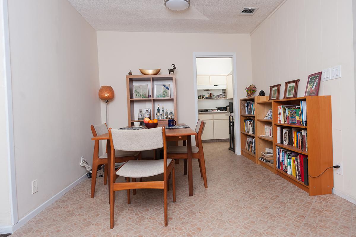 a living room filled with furniture and a book