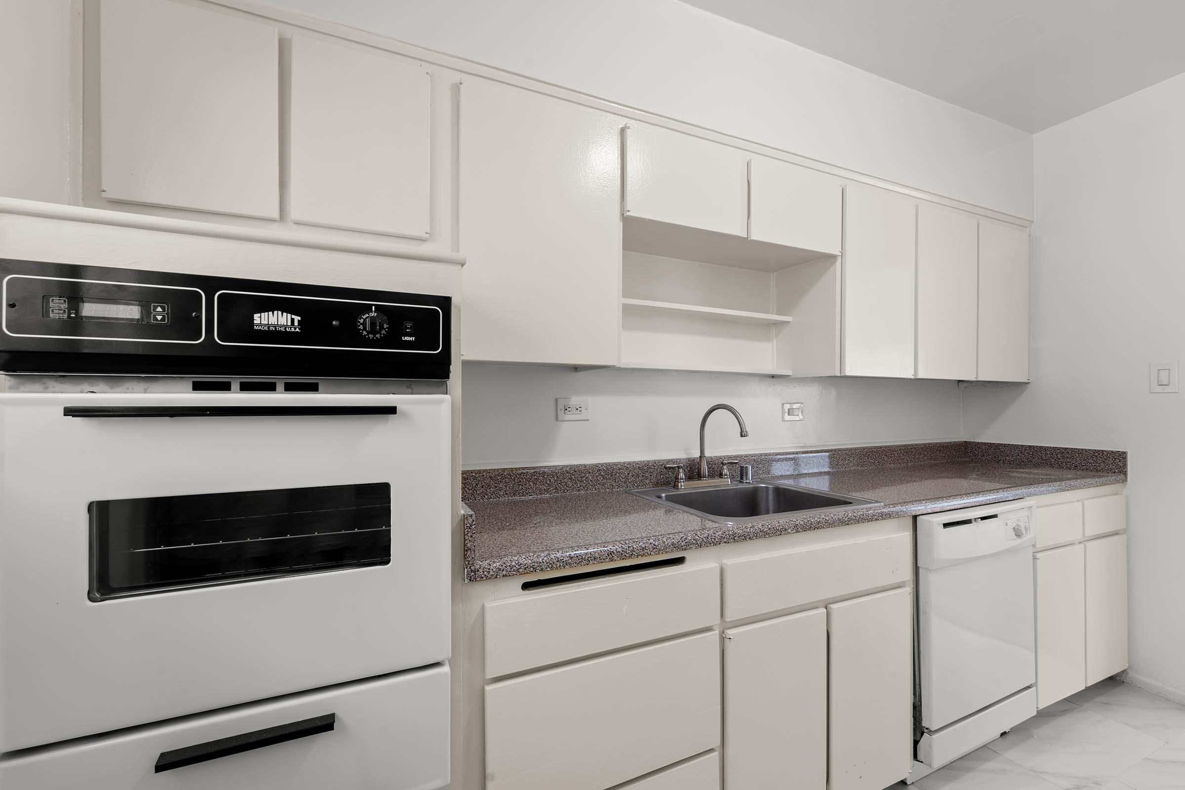 a stove top oven sitting inside of a kitchen