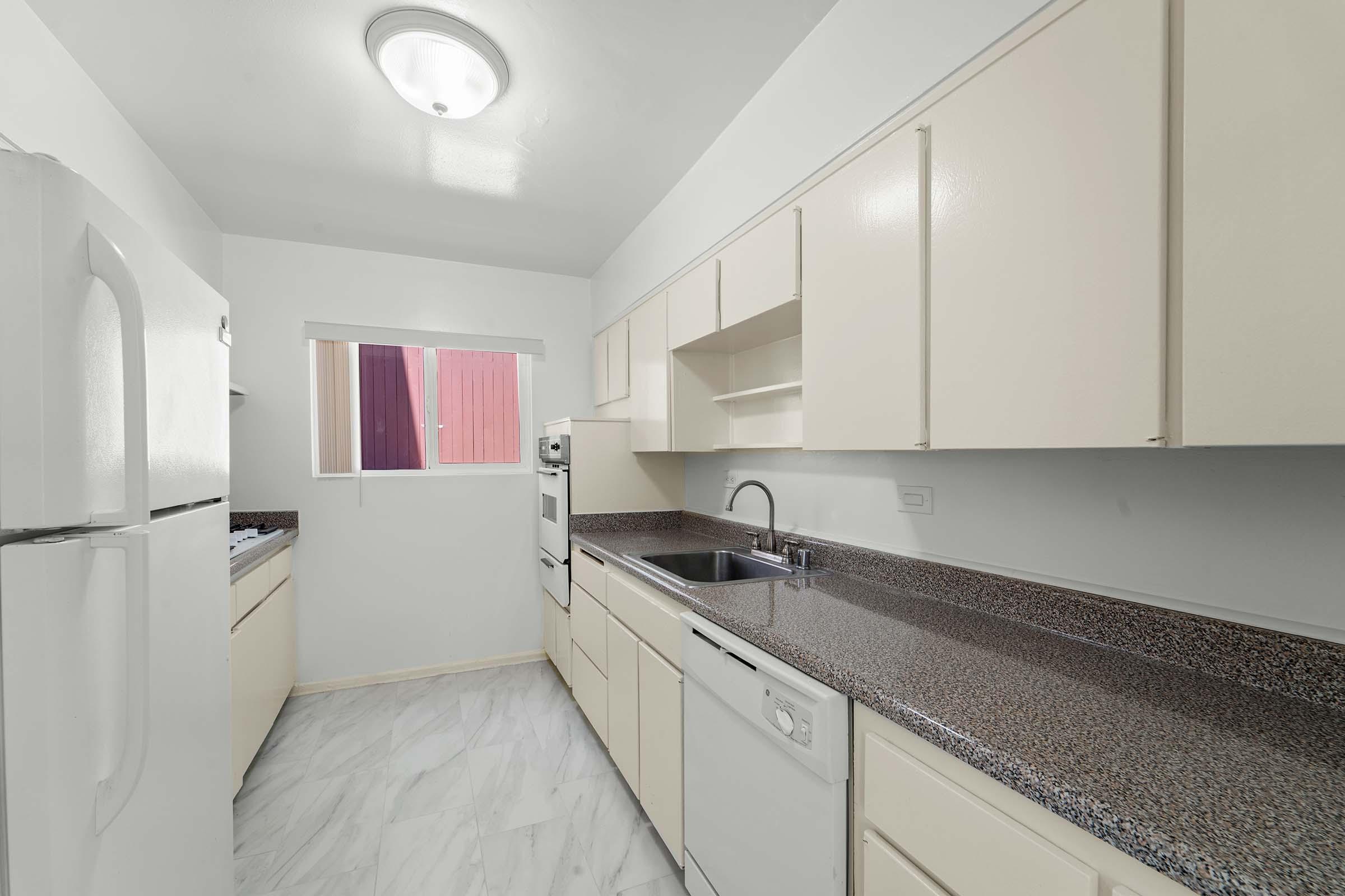 a kitchen with a sink and a refrigerator