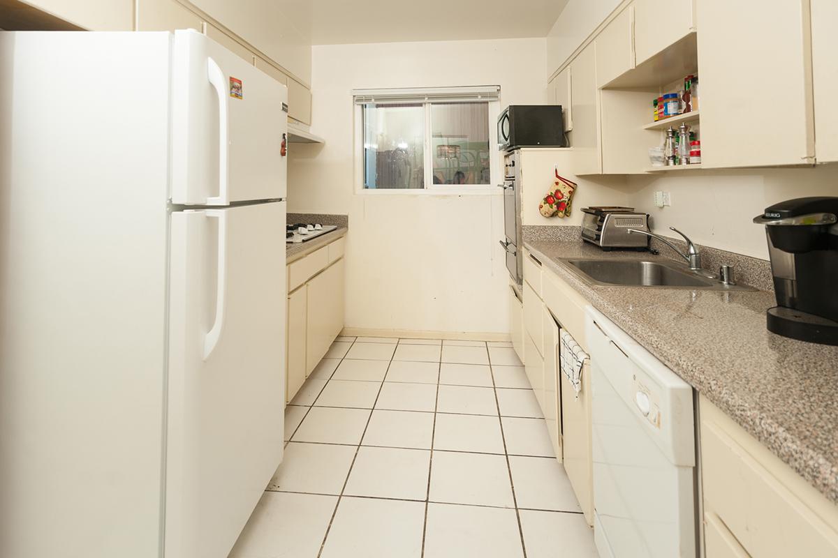 a white refrigerator freezer sitting inside of a kitchen