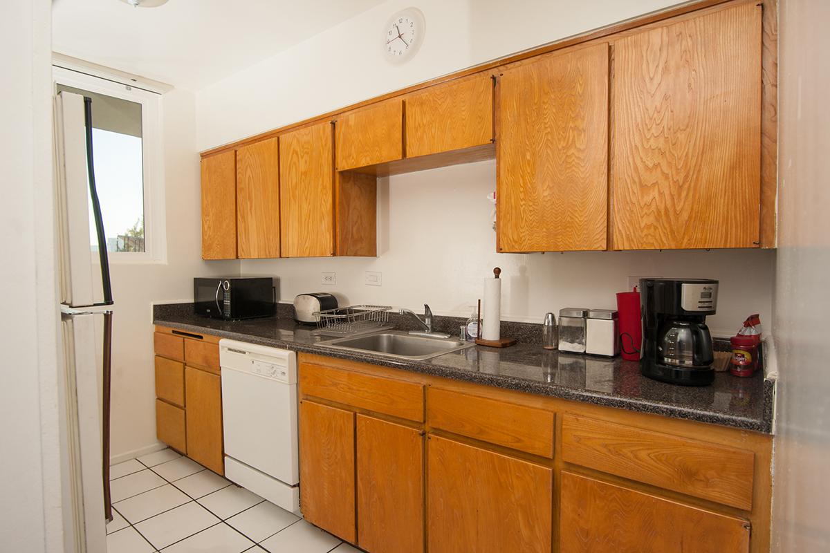 a kitchen with a stove sink and refrigerator