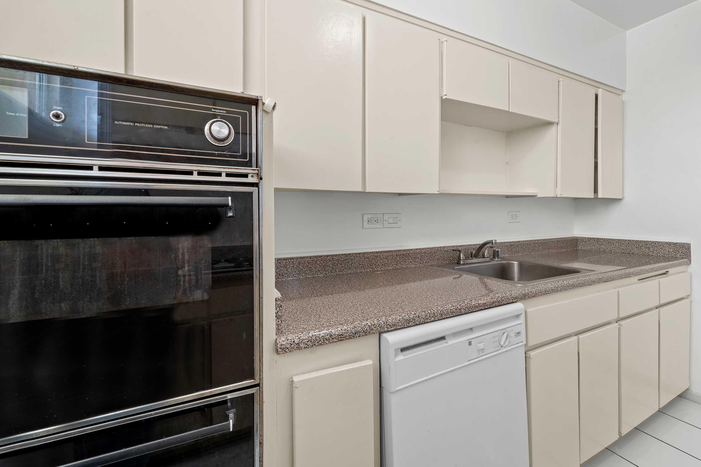 a kitchen with stainless steel appliances and wooden cabinets