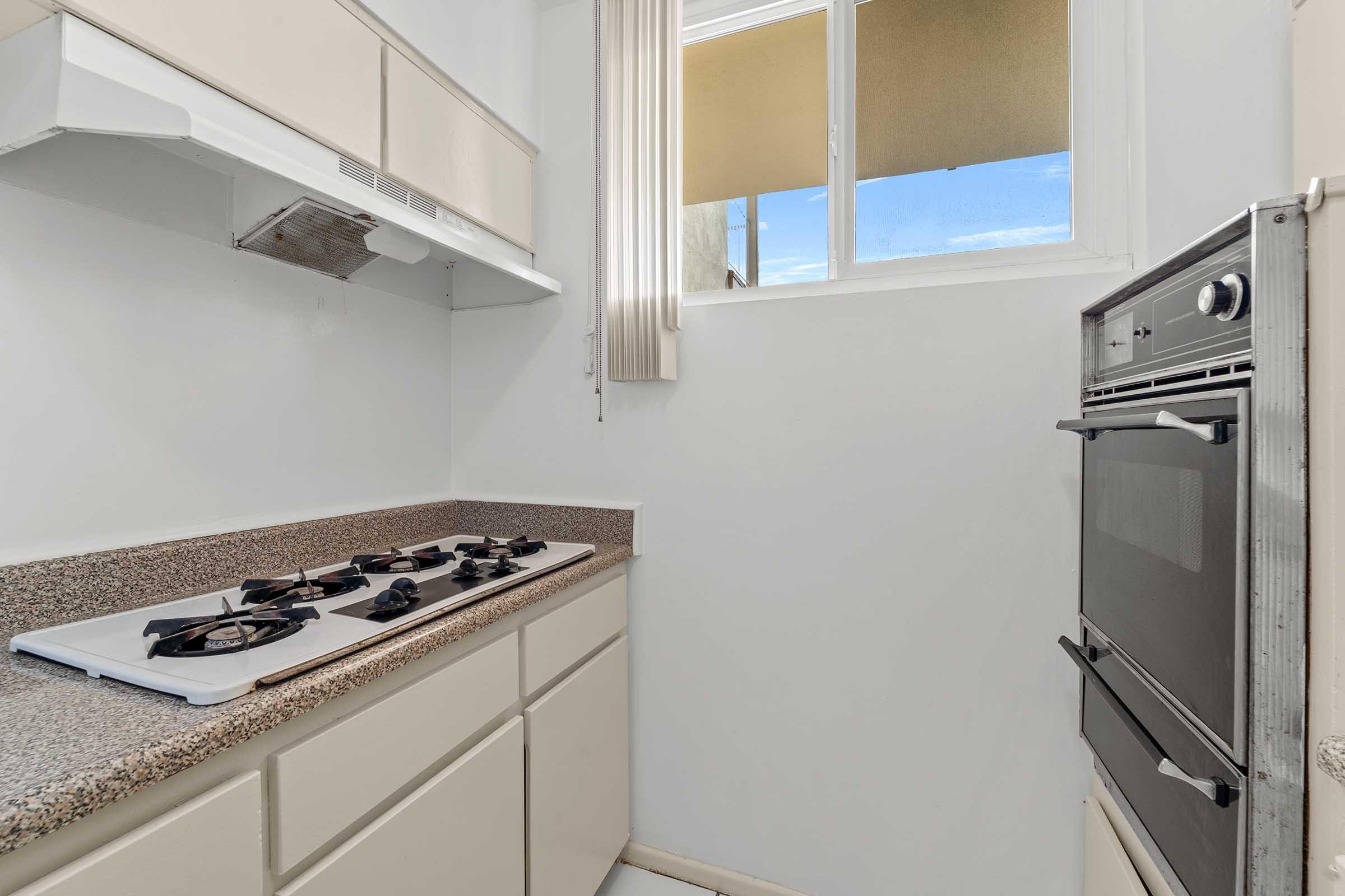 a kitchen with a stove and a sink