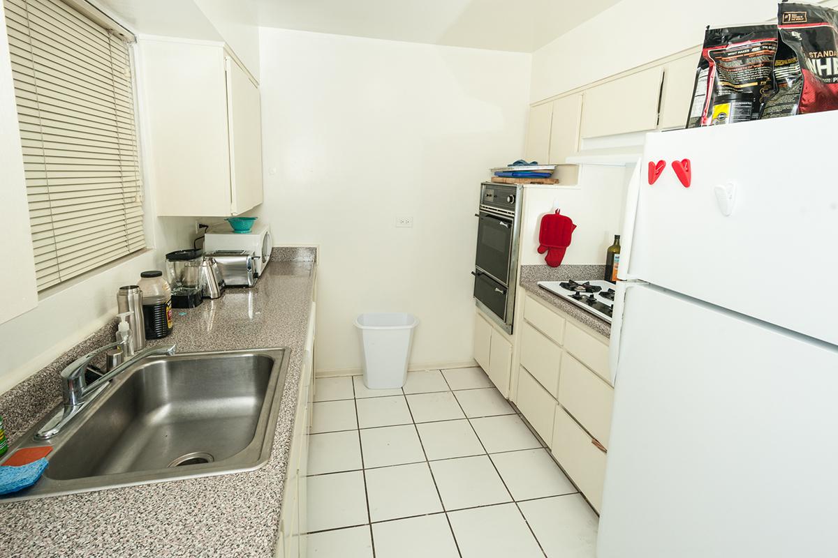 a kitchen with a sink and a refrigerator