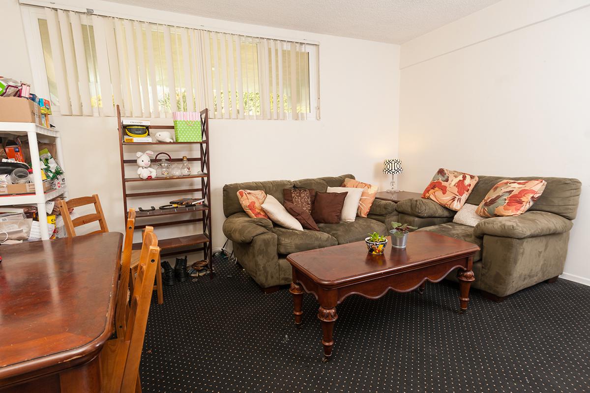 a living room filled with furniture and a tv