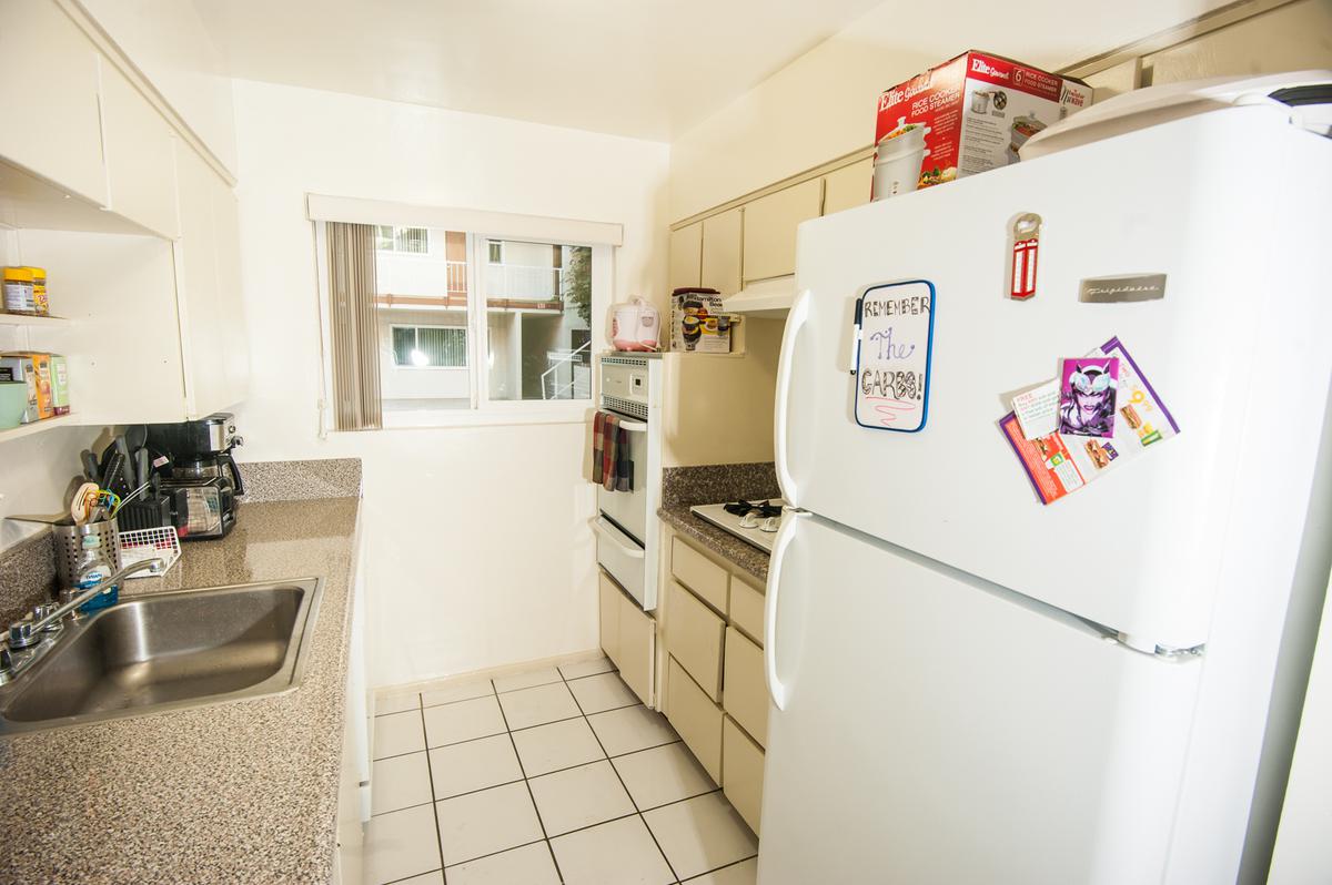 a white refrigerator freezer sitting inside of a kitchen