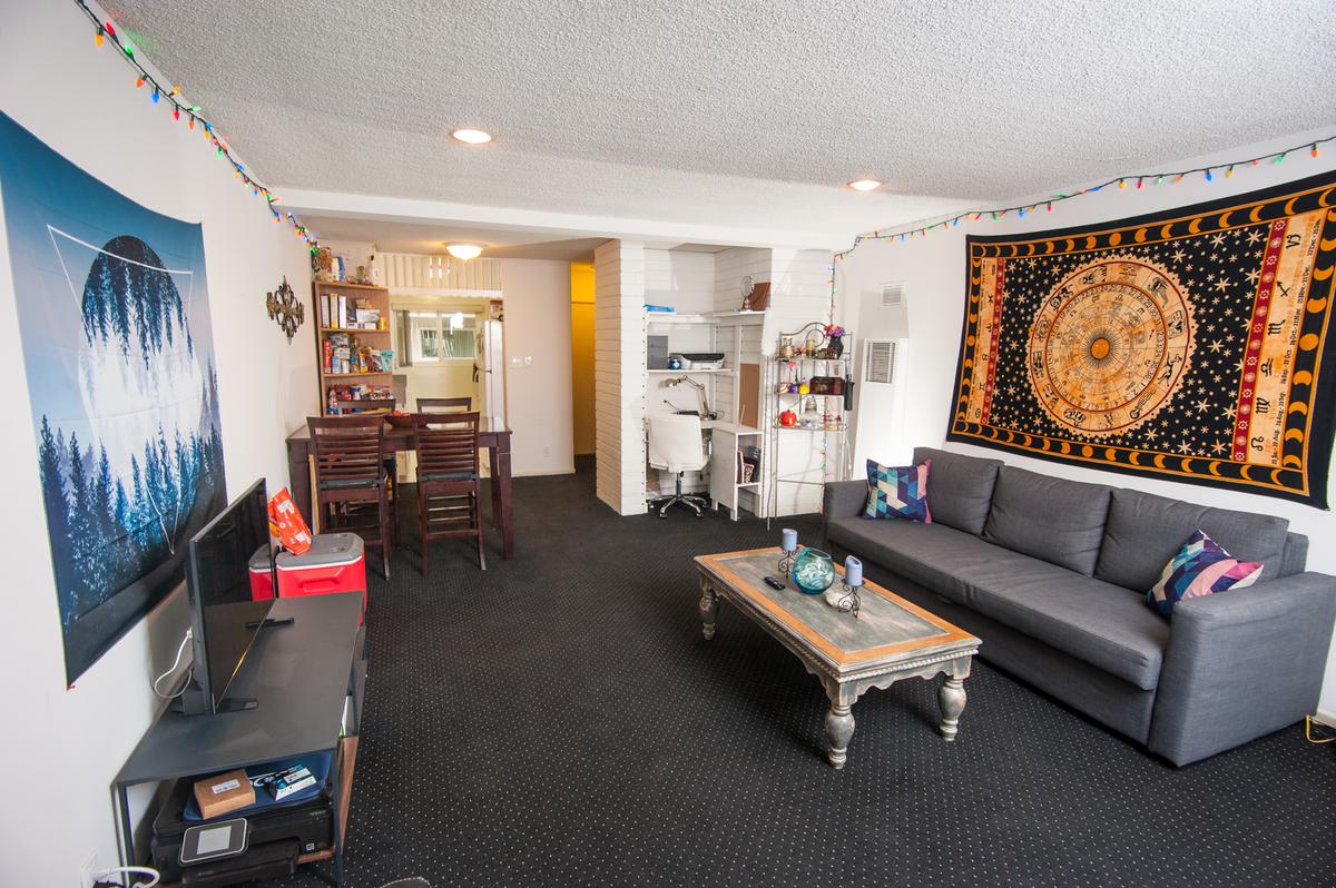 a living room filled with furniture and a flat screen tv