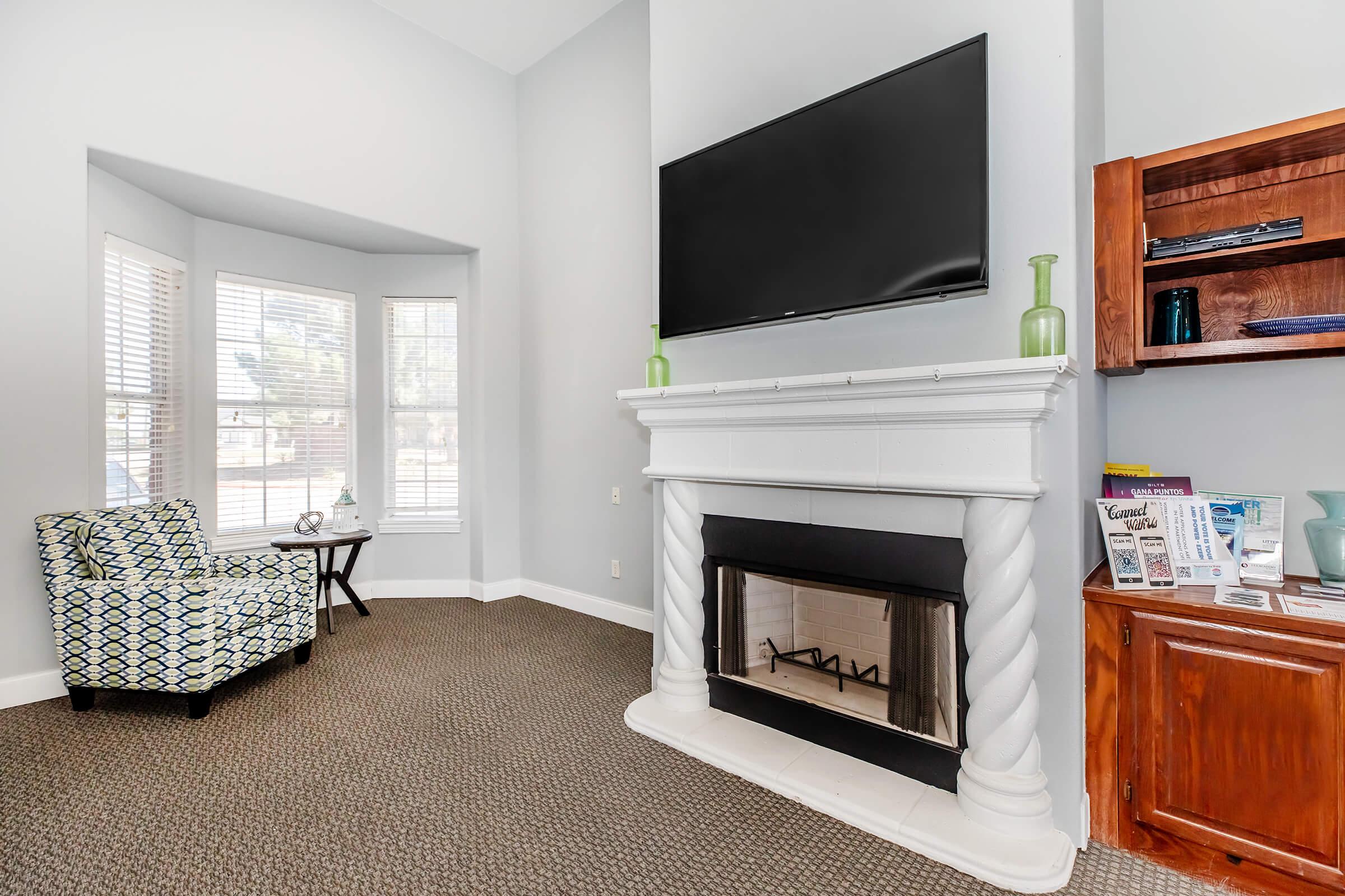 a living room filled with furniture and a fireplace