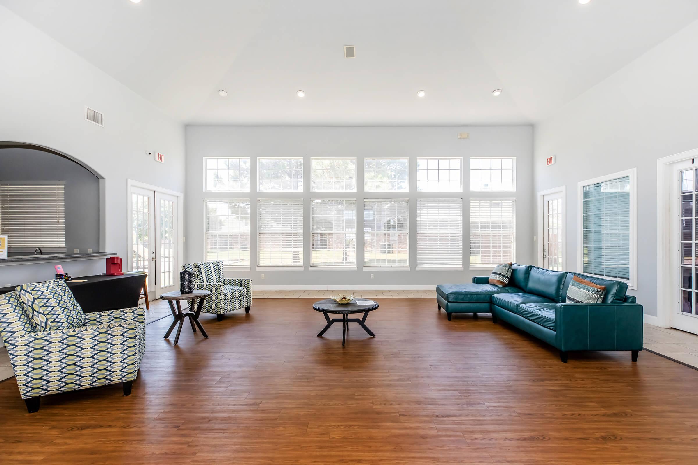 a living room filled with furniture and a large window