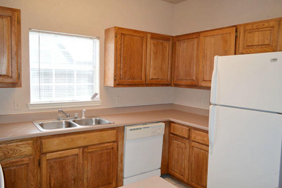 a kitchen with stainless steel appliances and wooden cabinets