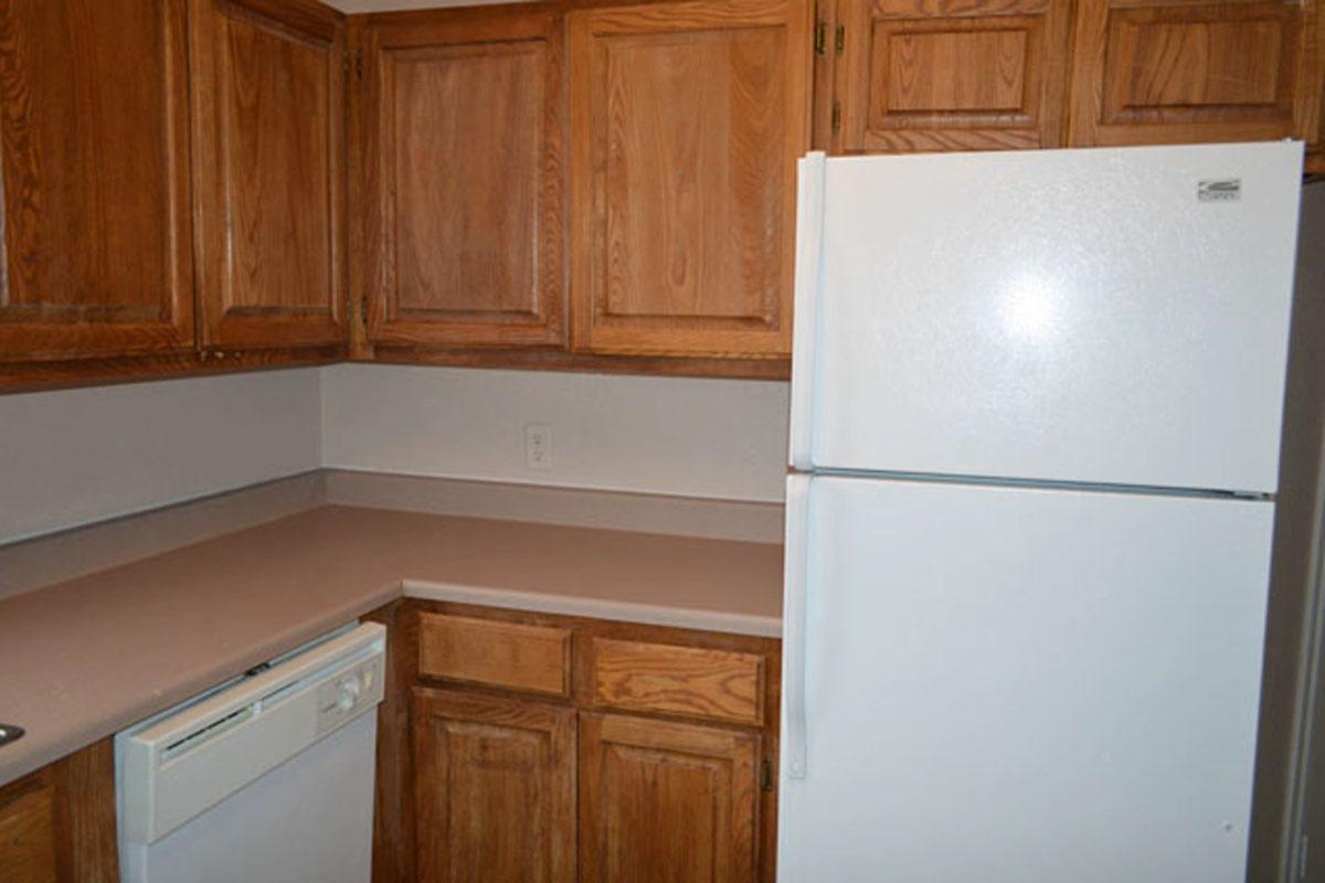 a kitchen with a microwave oven sitting on top of a refrigerator