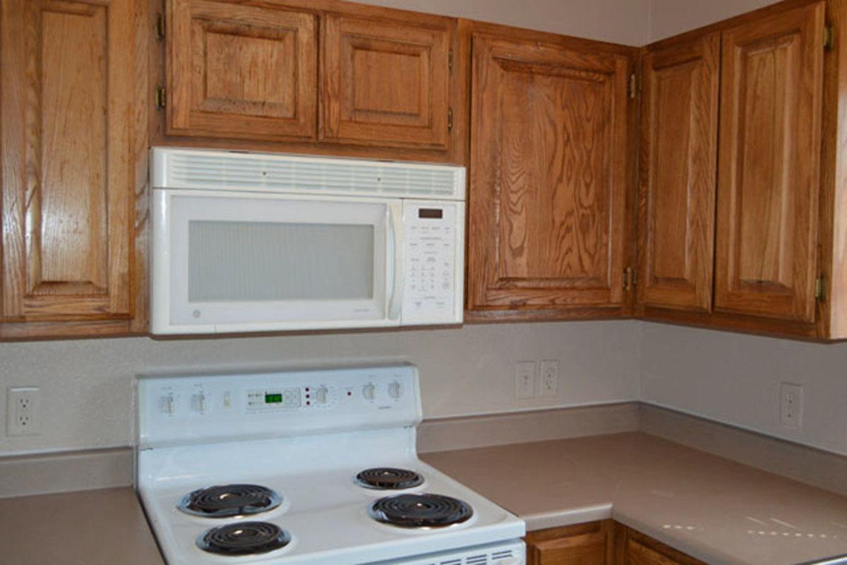 a kitchen with a stove top oven sitting next to a microwave