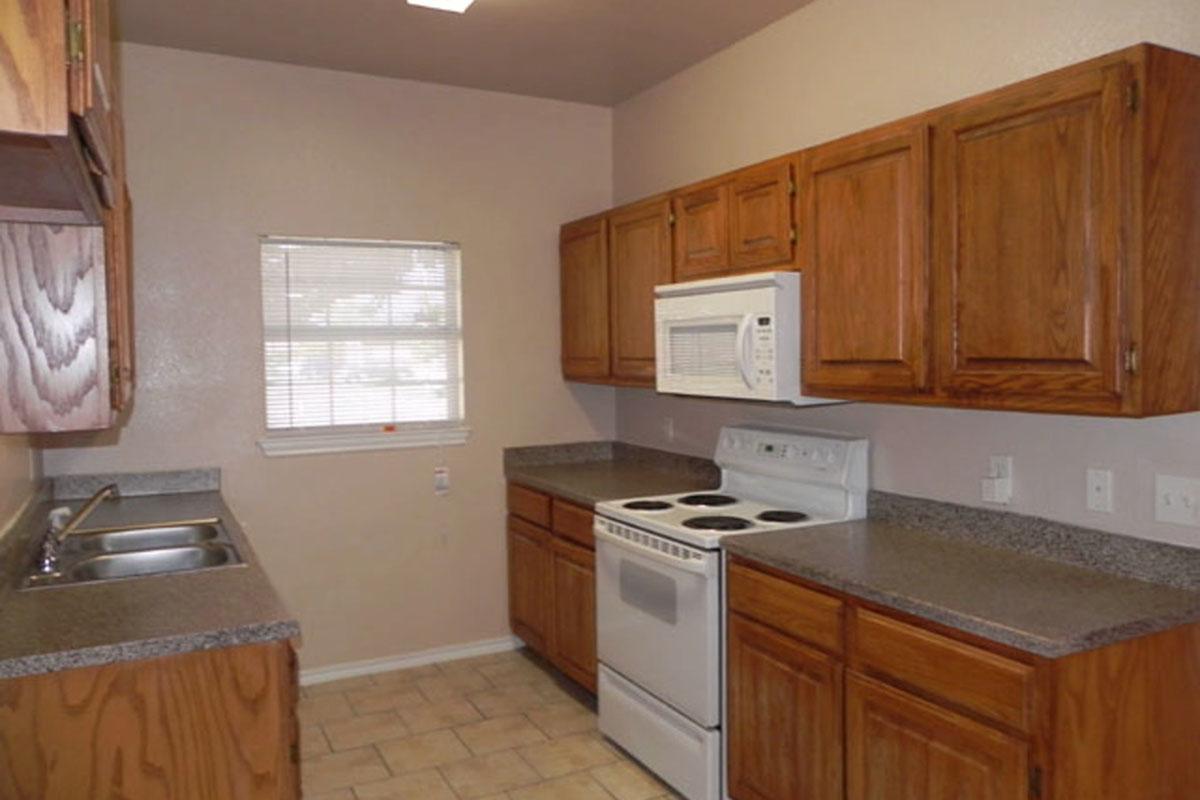 a kitchen with stainless steel appliances and wooden cabinets