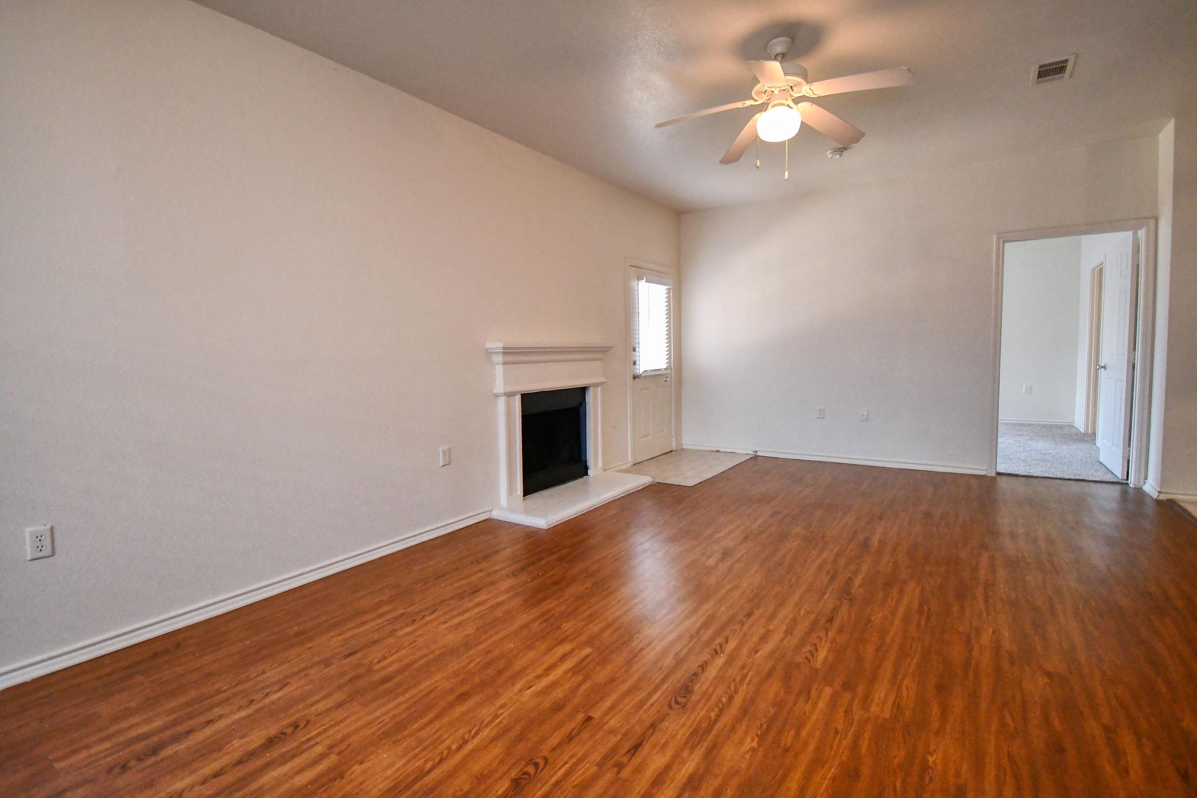 a large empty room with a hard wood floor