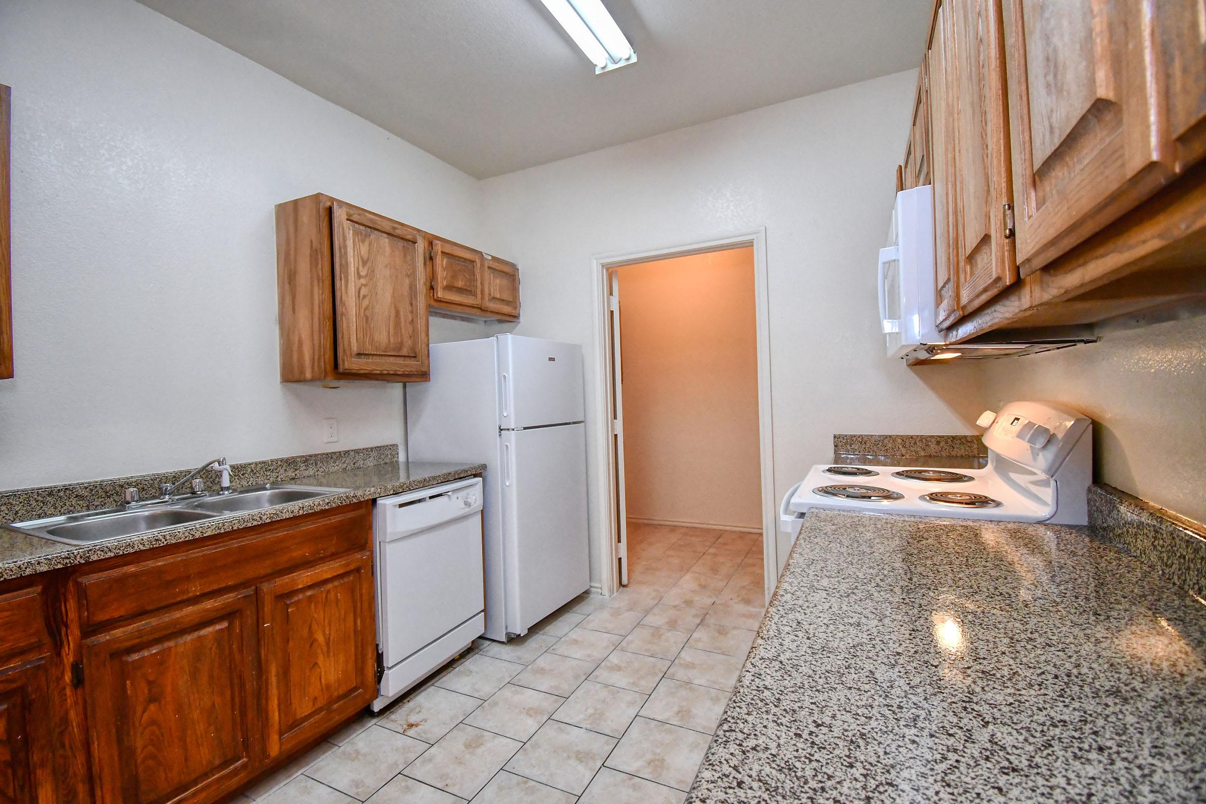 a kitchen with a sink and a refrigerator