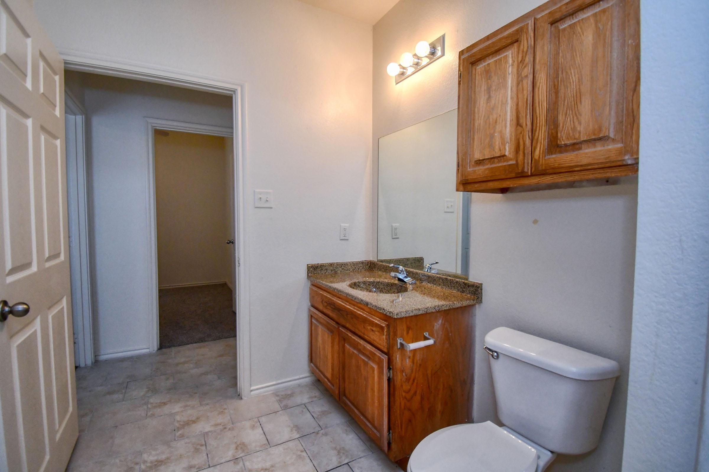 a kitchen with a sink and a mirror