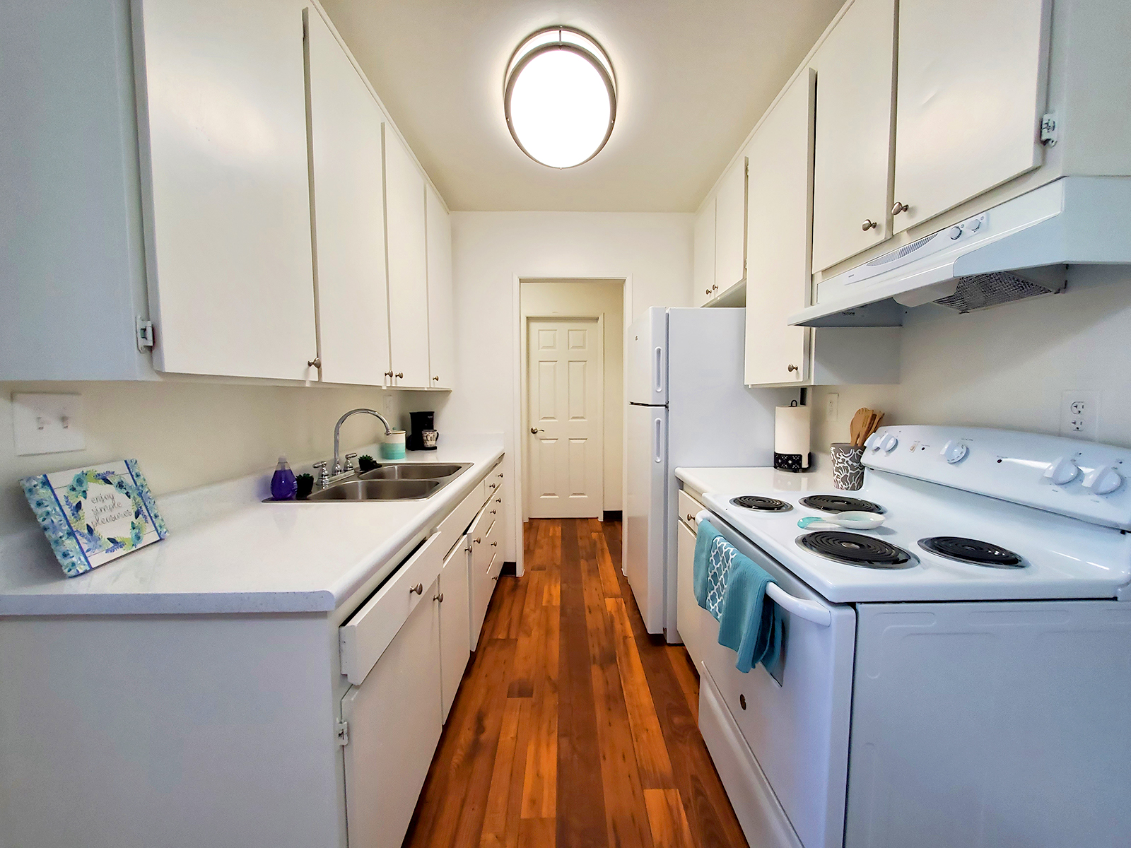 a stove top oven sitting inside of a kitchen