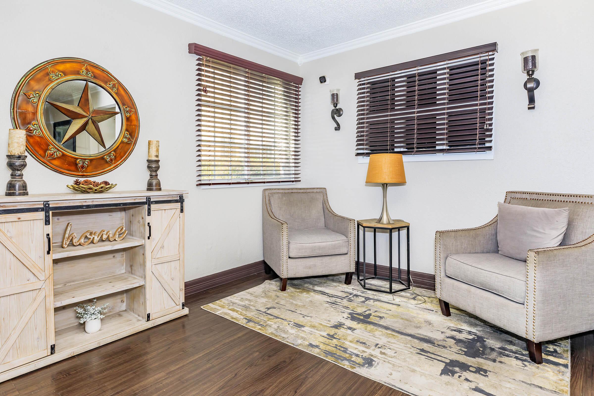 a living room filled with furniture and a clock