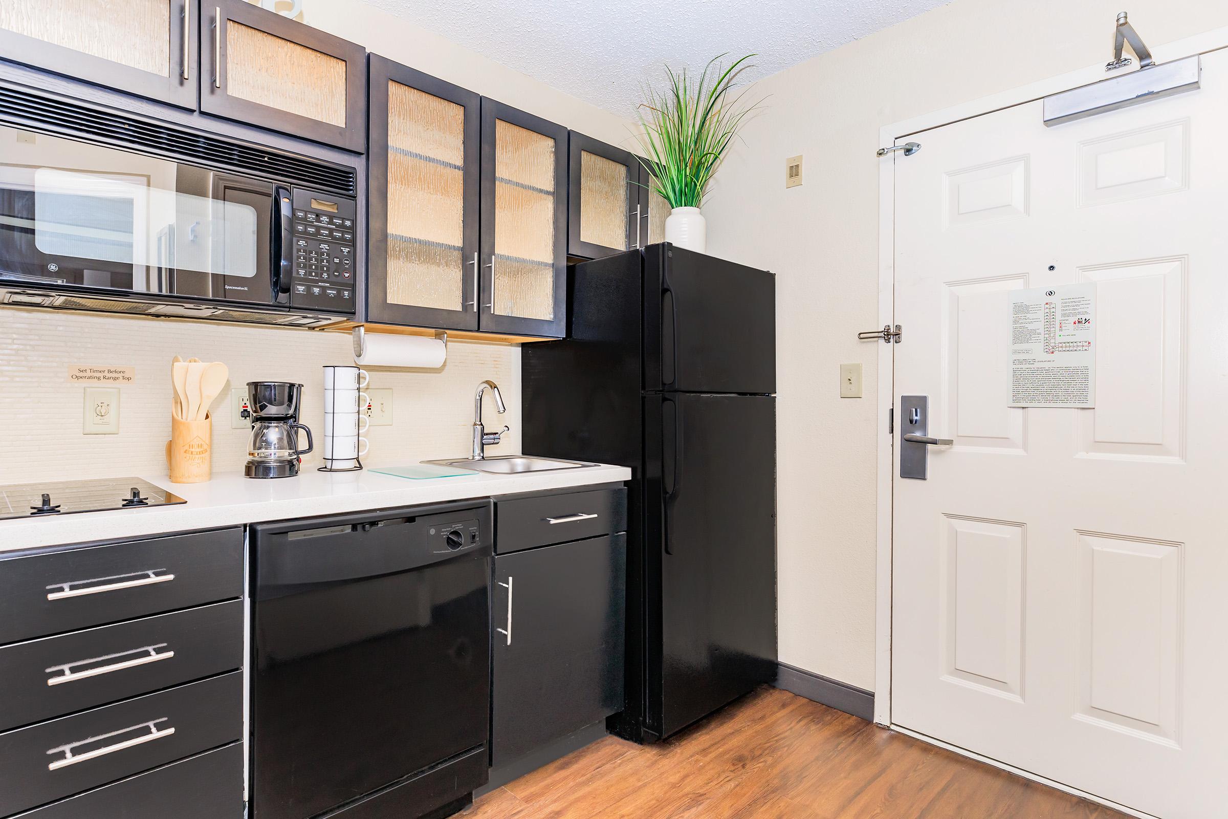 a stove top oven sitting inside of a kitchen