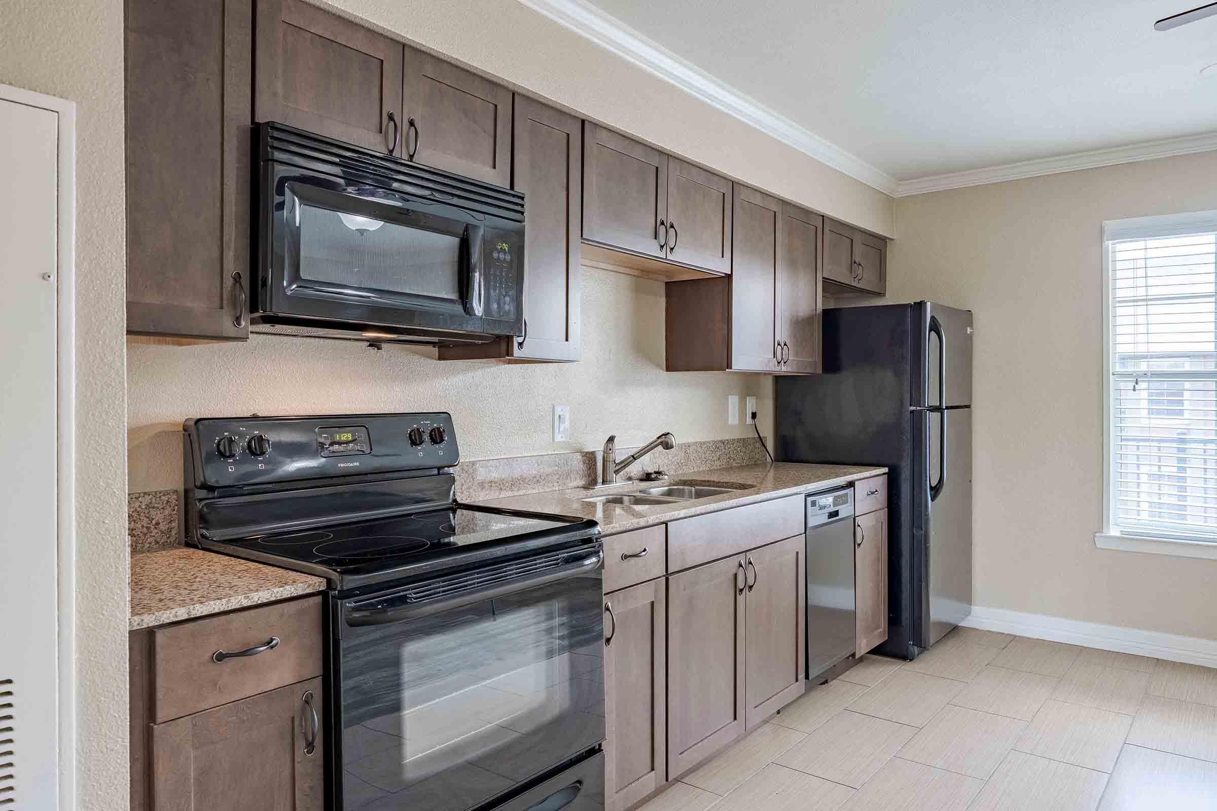 a stove top oven sitting inside of a kitchen