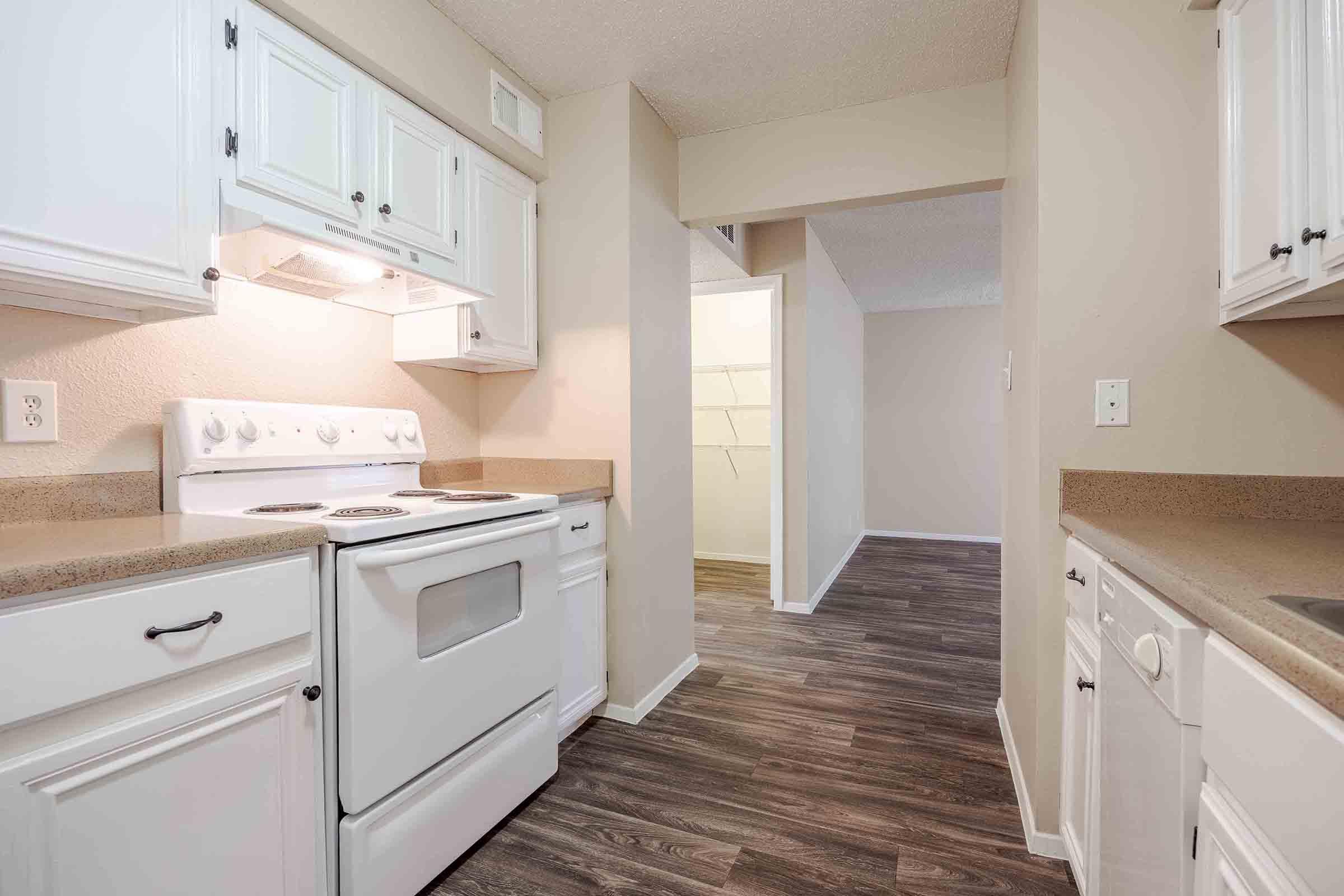 a stove top oven sitting inside of a kitchen