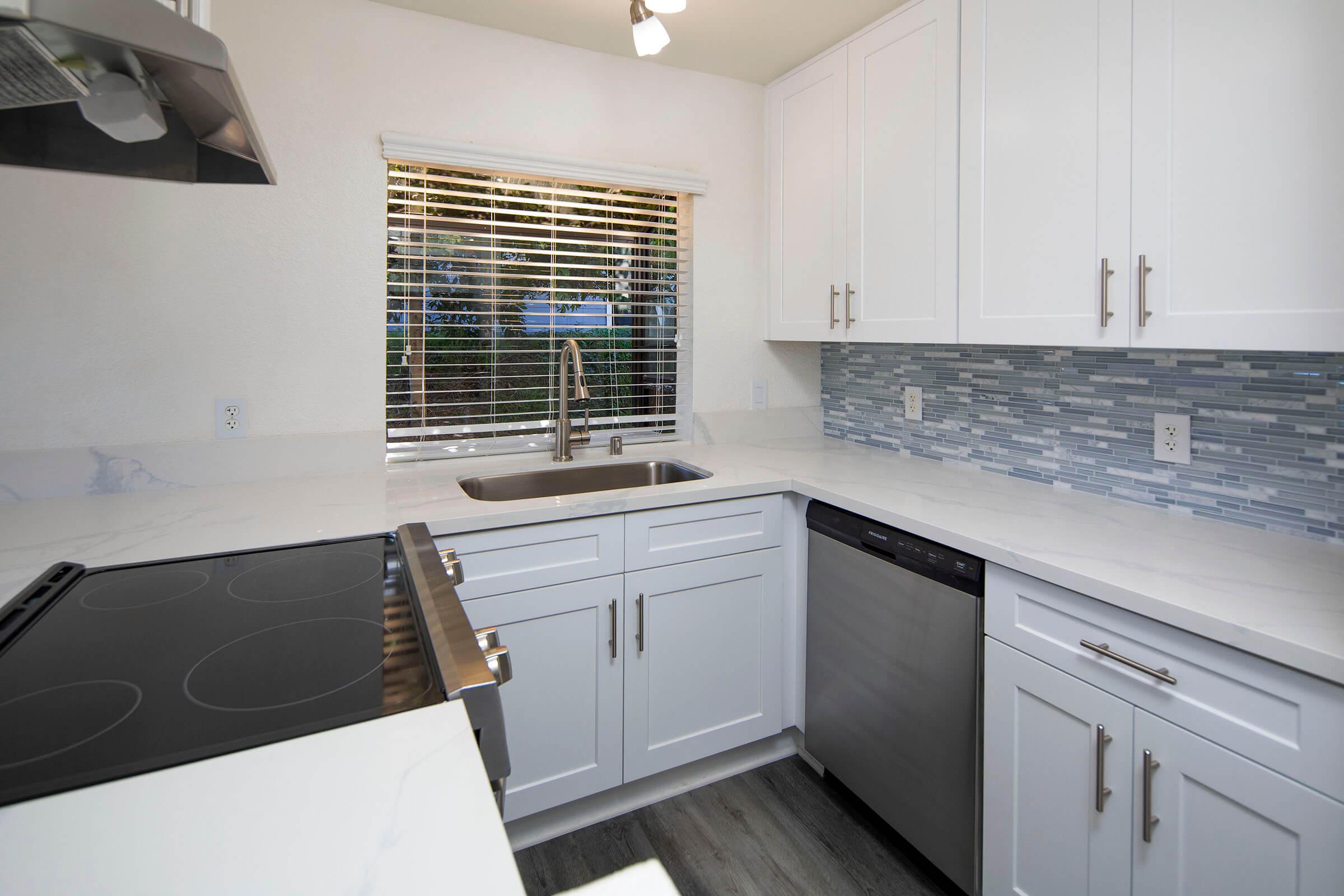 a kitchen with a stove and a sink