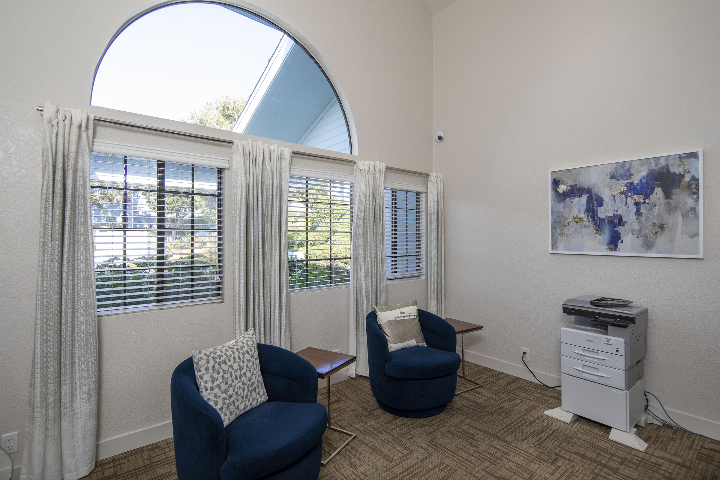 a living room filled with furniture and a large window