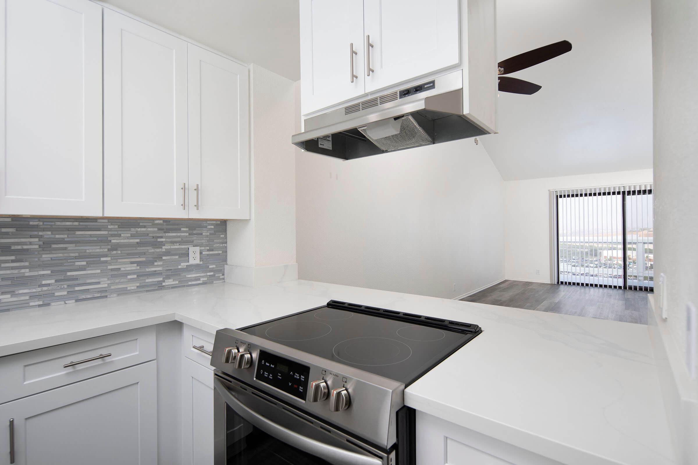 a stove top oven sitting inside of a kitchen