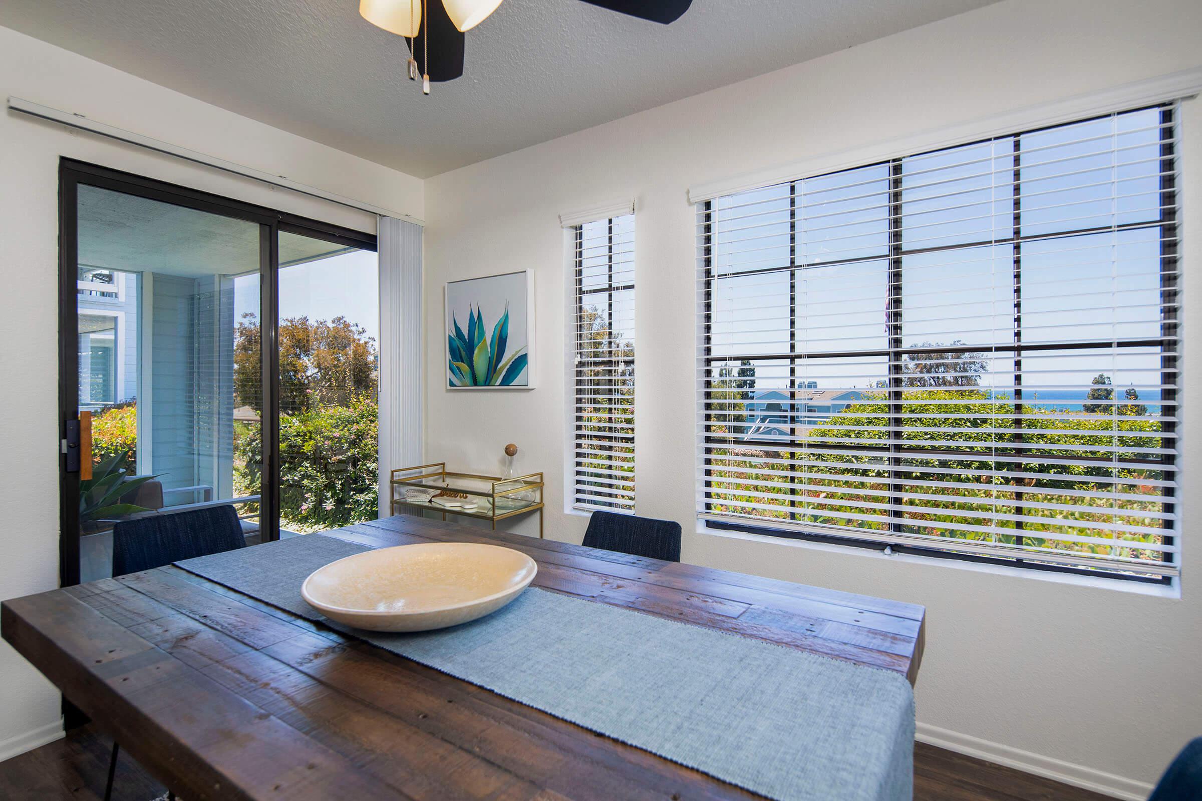 a living room filled with furniture and a large window