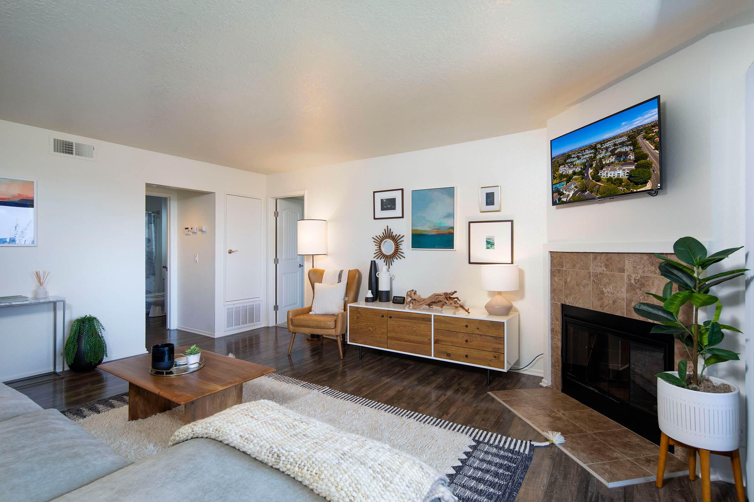 a living room filled with furniture and a flat screen tv