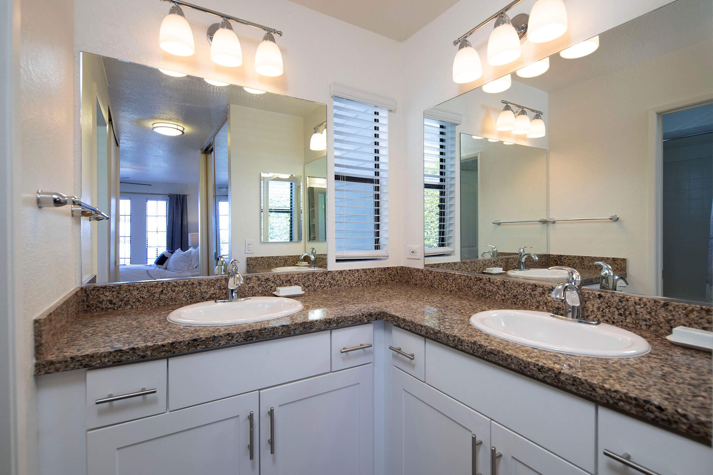 a kitchen with a sink and a mirror