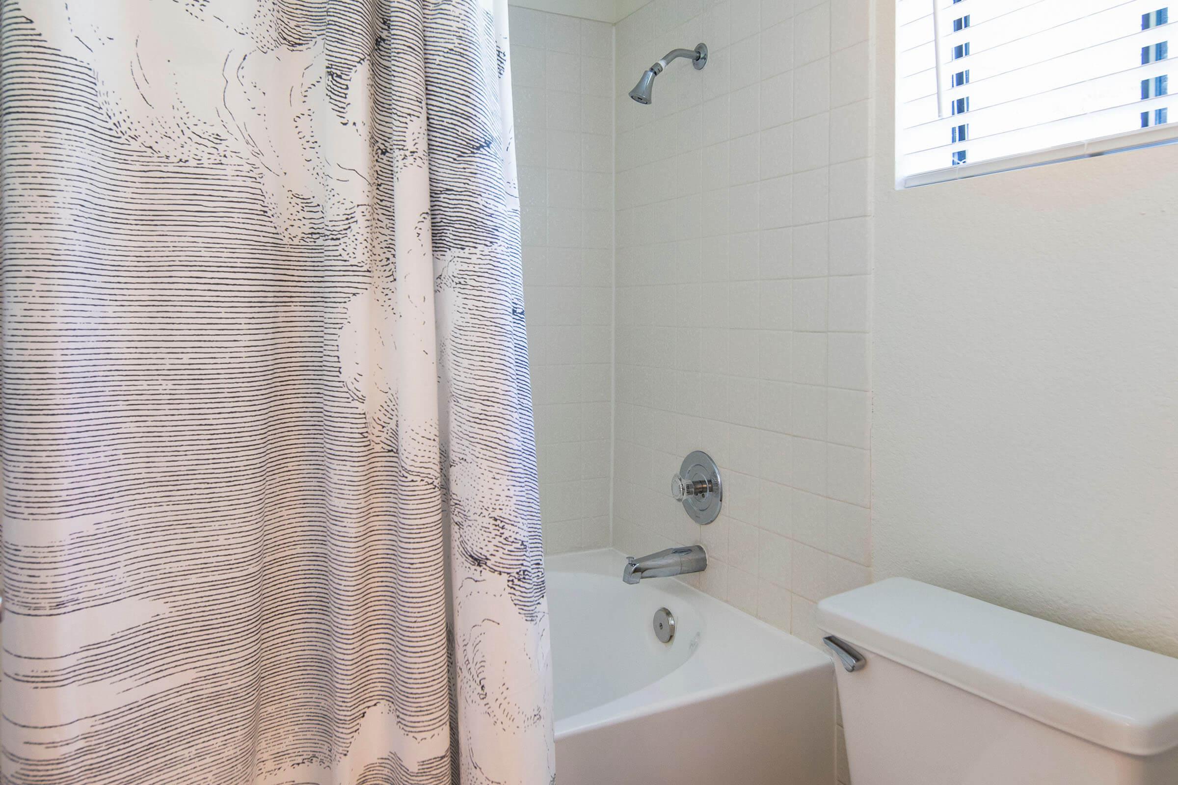 a shower curtain next to a sink