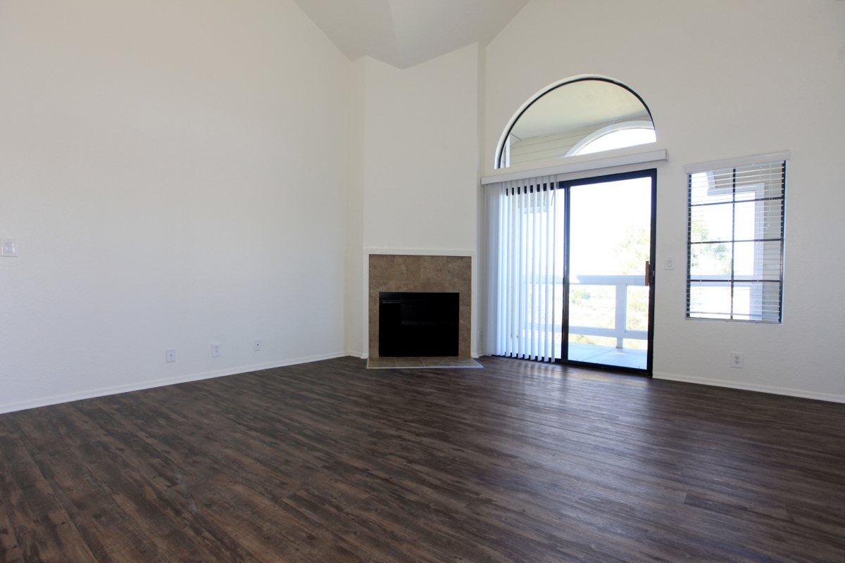 a large empty room with a wooden floor