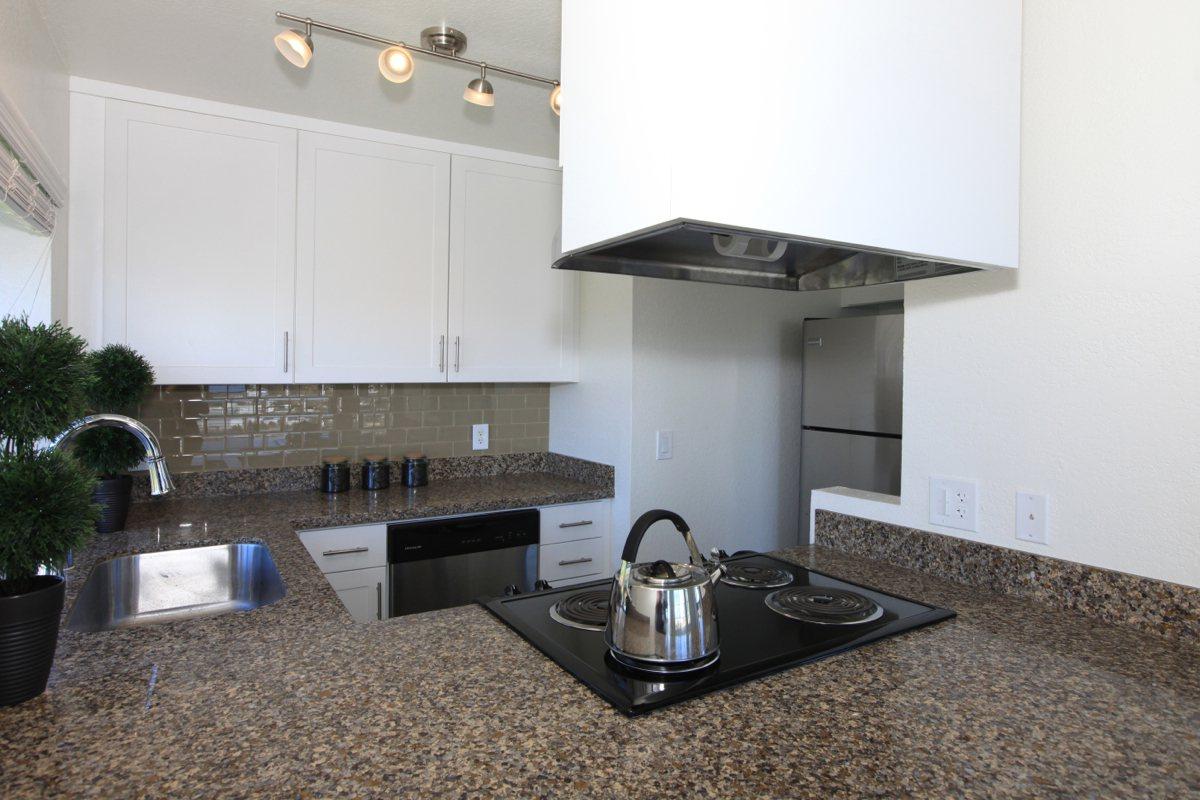 a stove top oven sitting inside of a kitchen