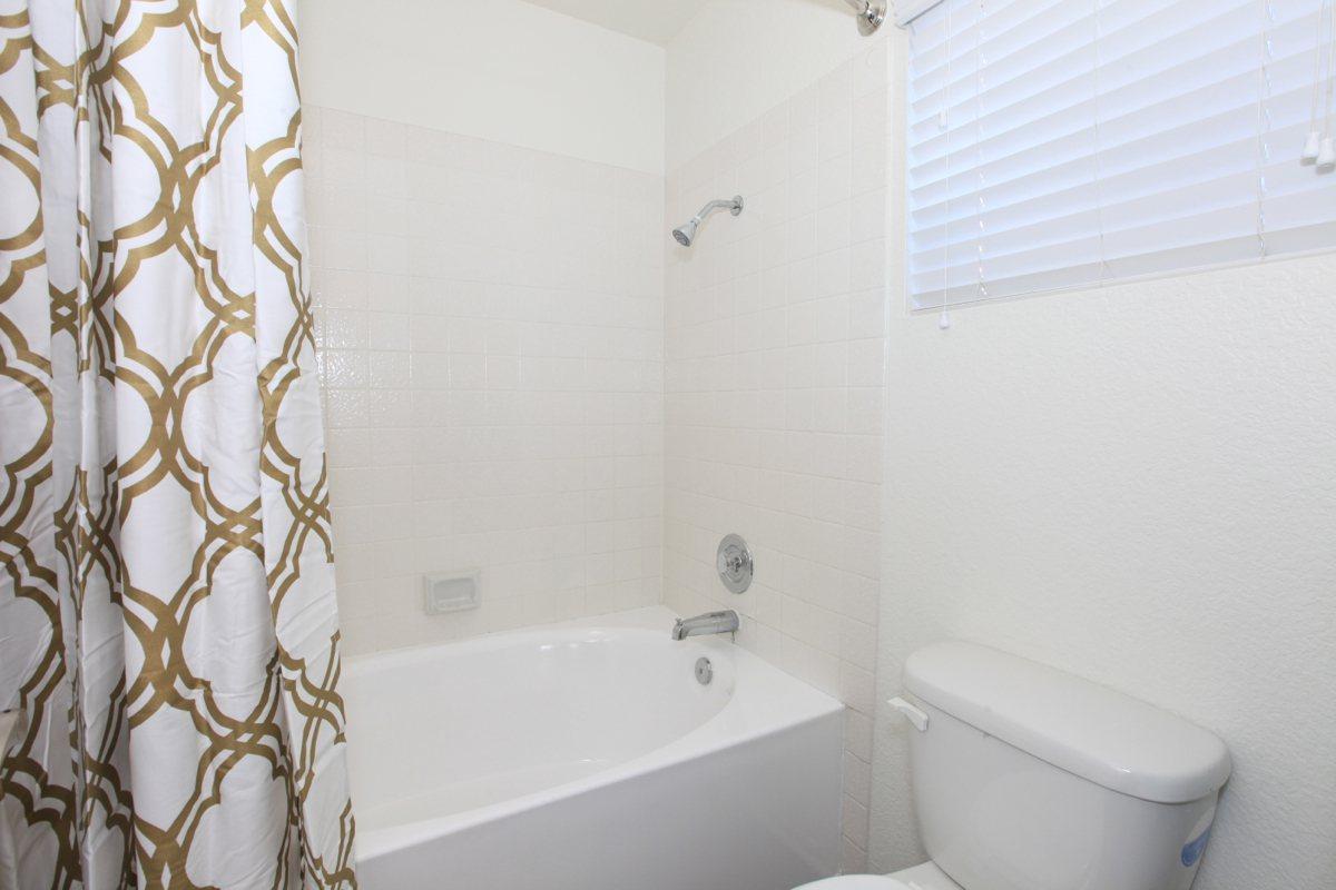 a white tub sitting next to a shower