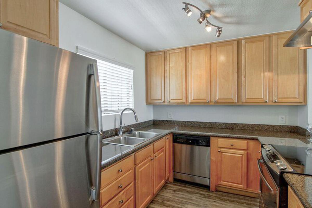 a kitchen with stainless steel appliances and wooden cabinets