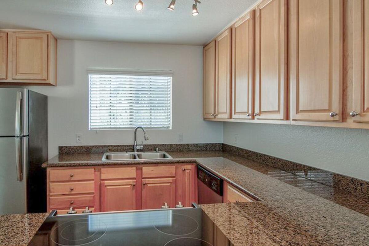 a kitchen with stainless steel appliances and wooden cabinets